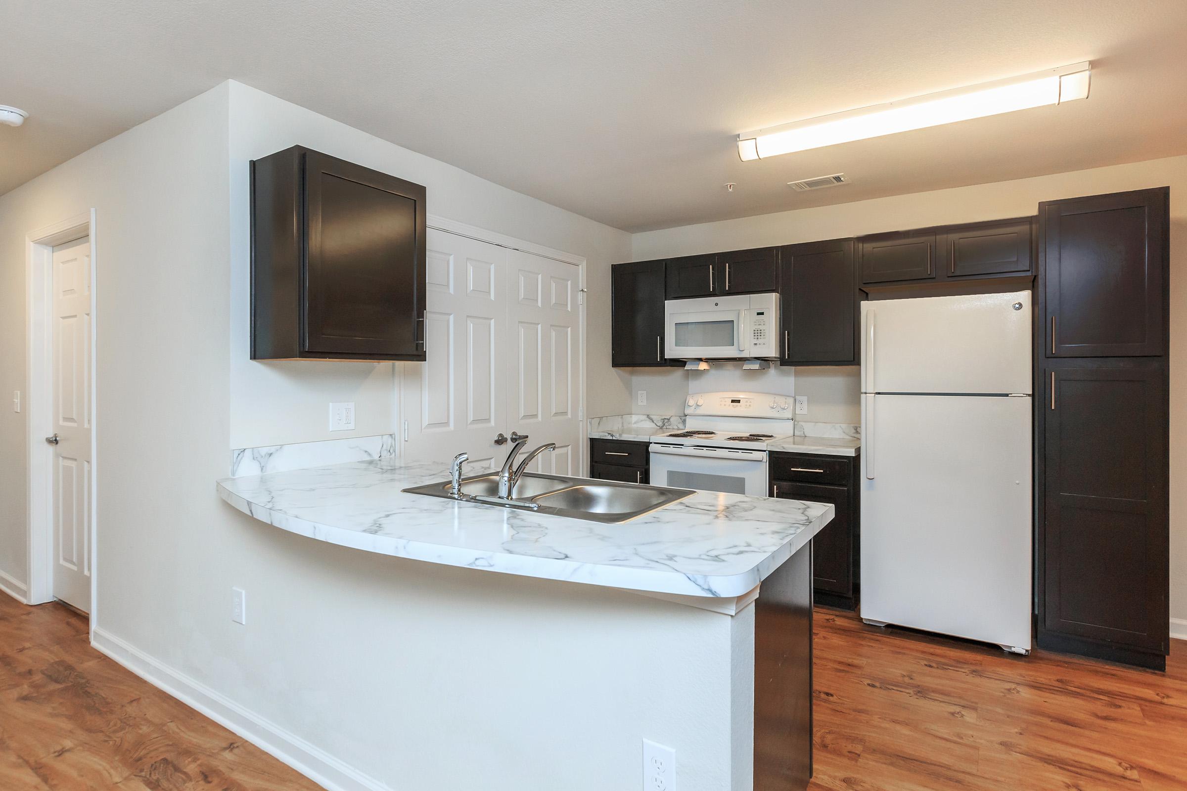 a kitchen with a sink and a refrigerator