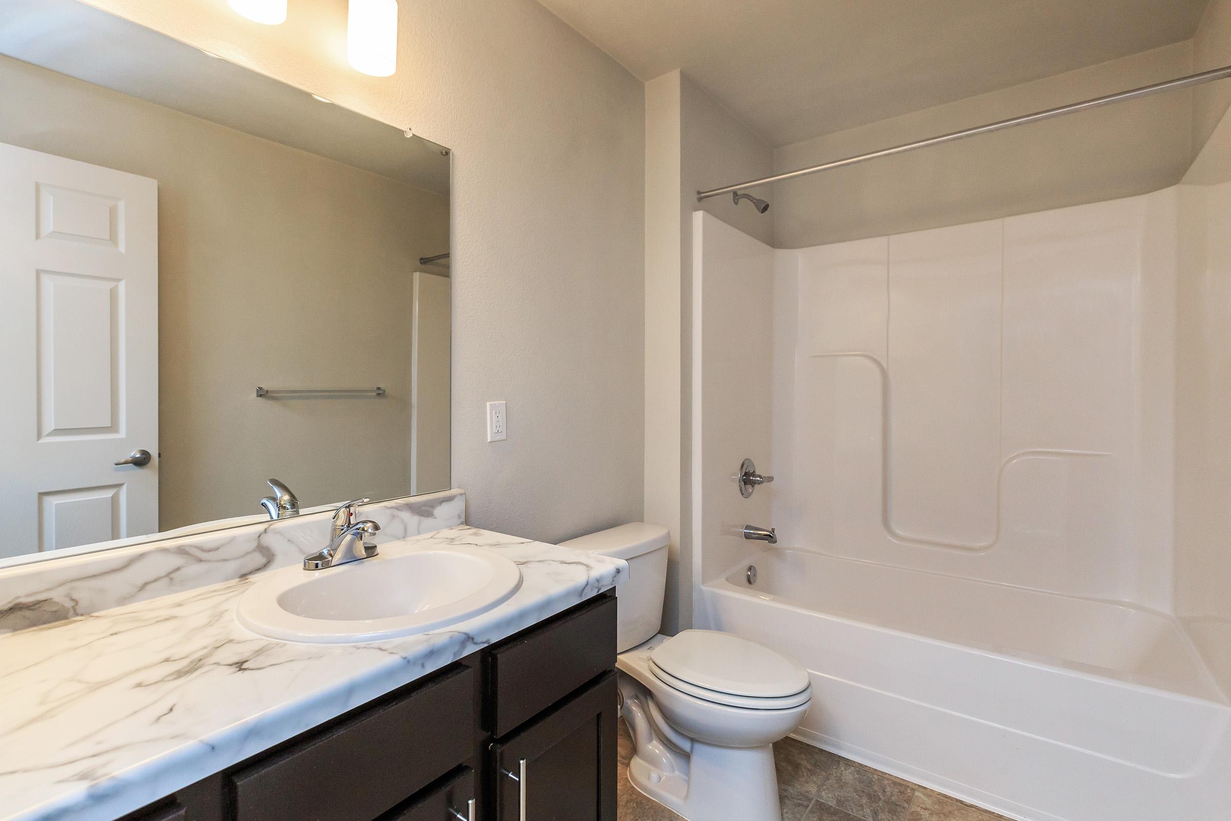 a large white tub next to a sink