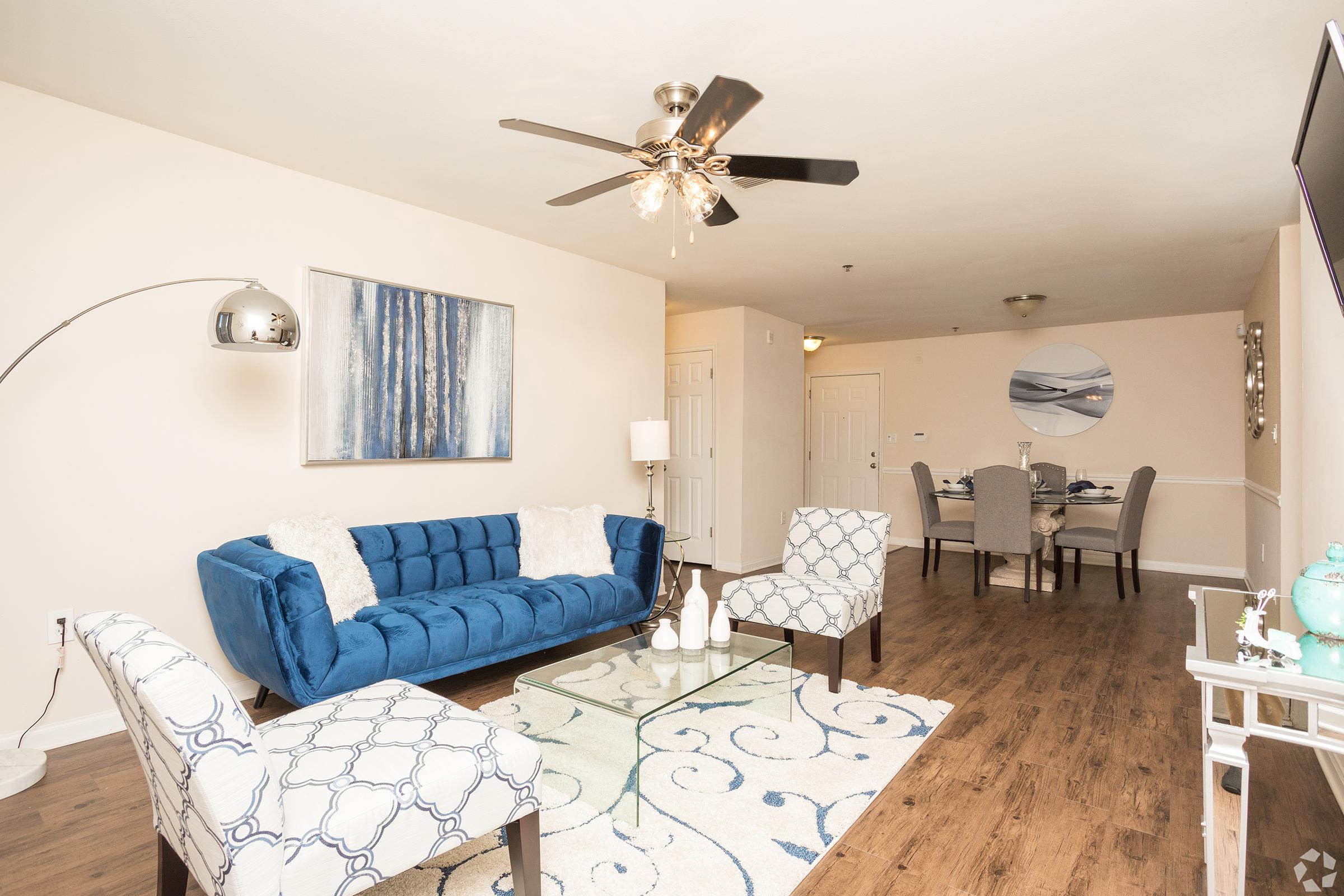 a living room filled with furniture and a bed