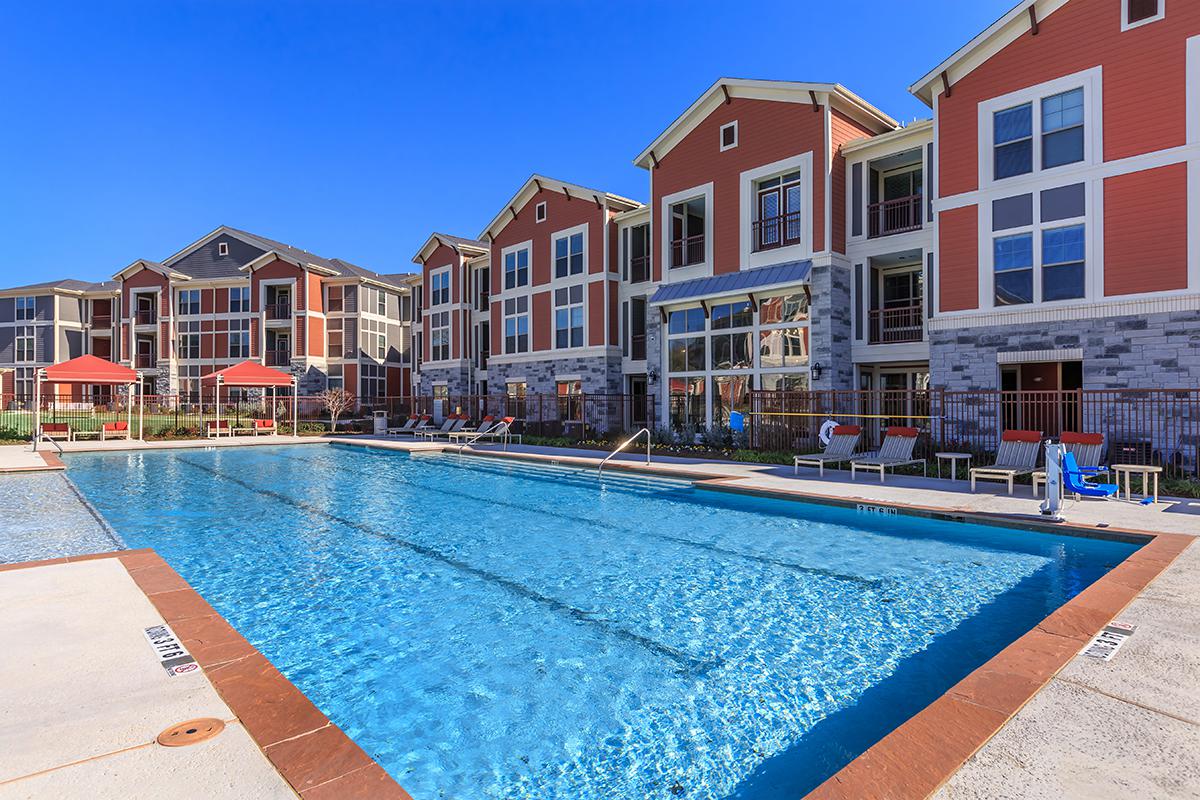 a house with a pool in front of a building