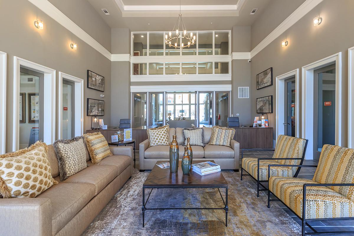 a living room filled with furniture and a large window