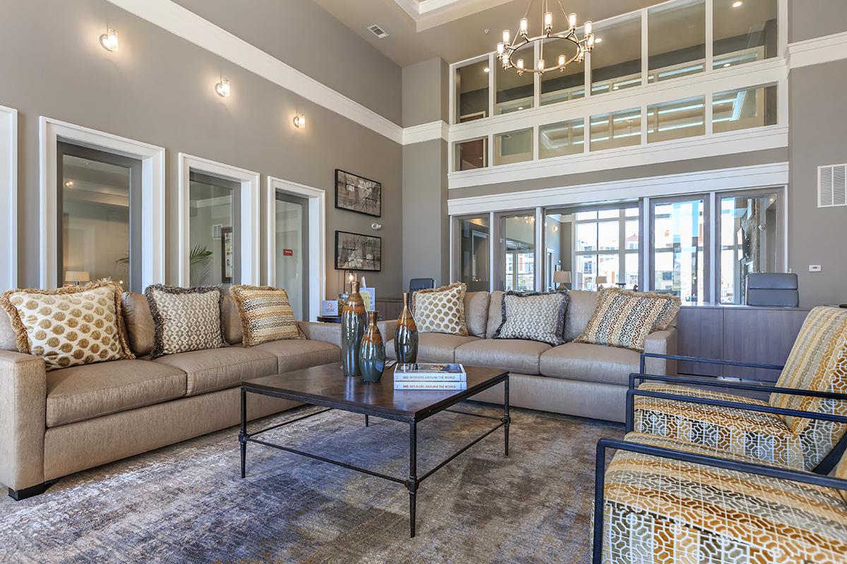 a living room filled with furniture and a large window