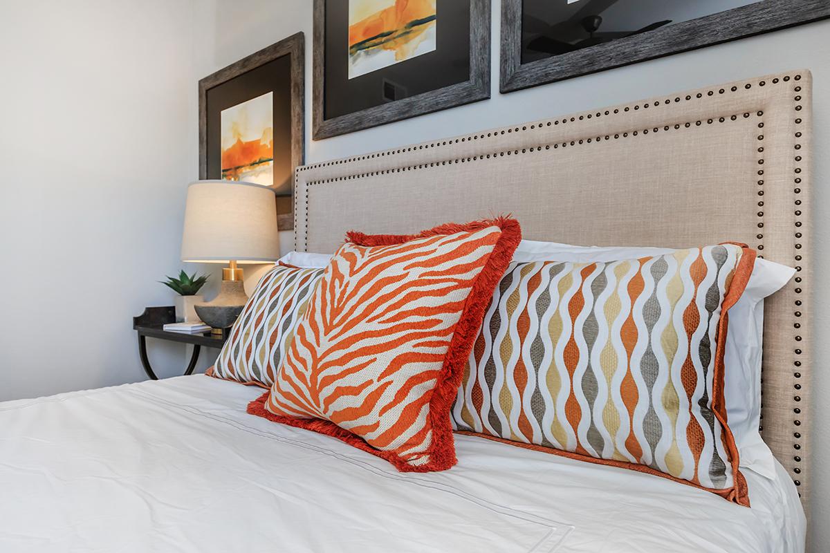 a large white bed sitting in a room