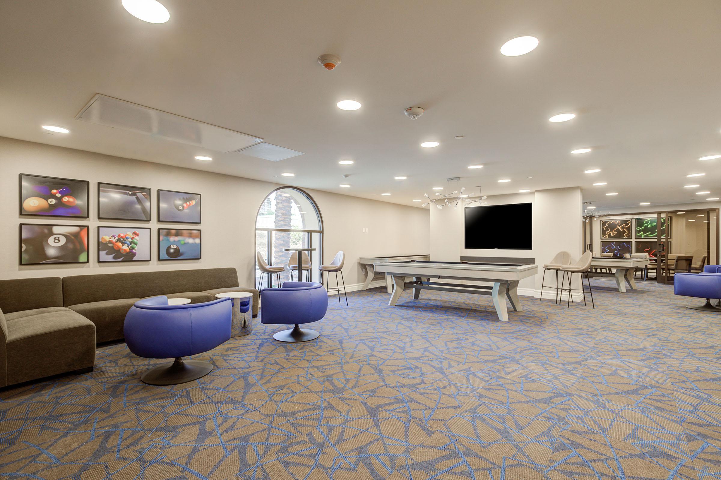 a room filled with furniture and a blue chair