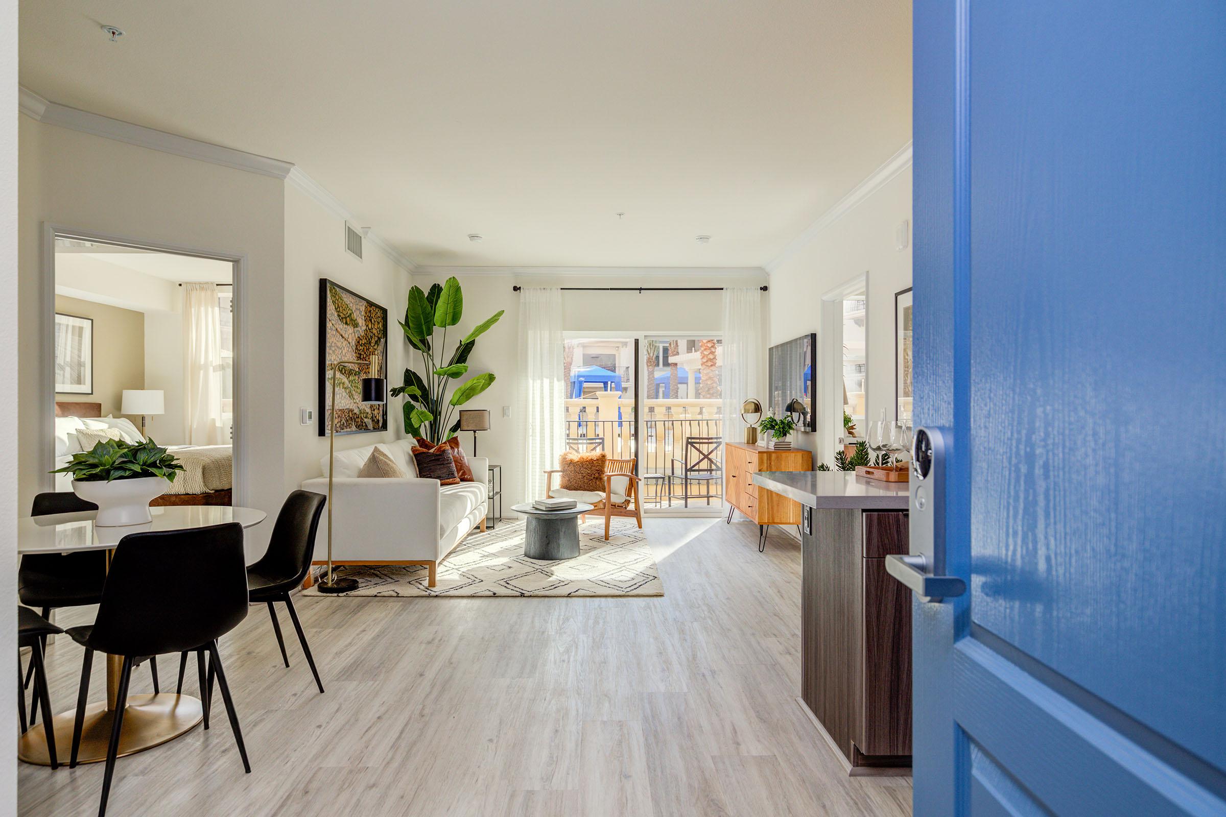 a living room filled with furniture and a large window