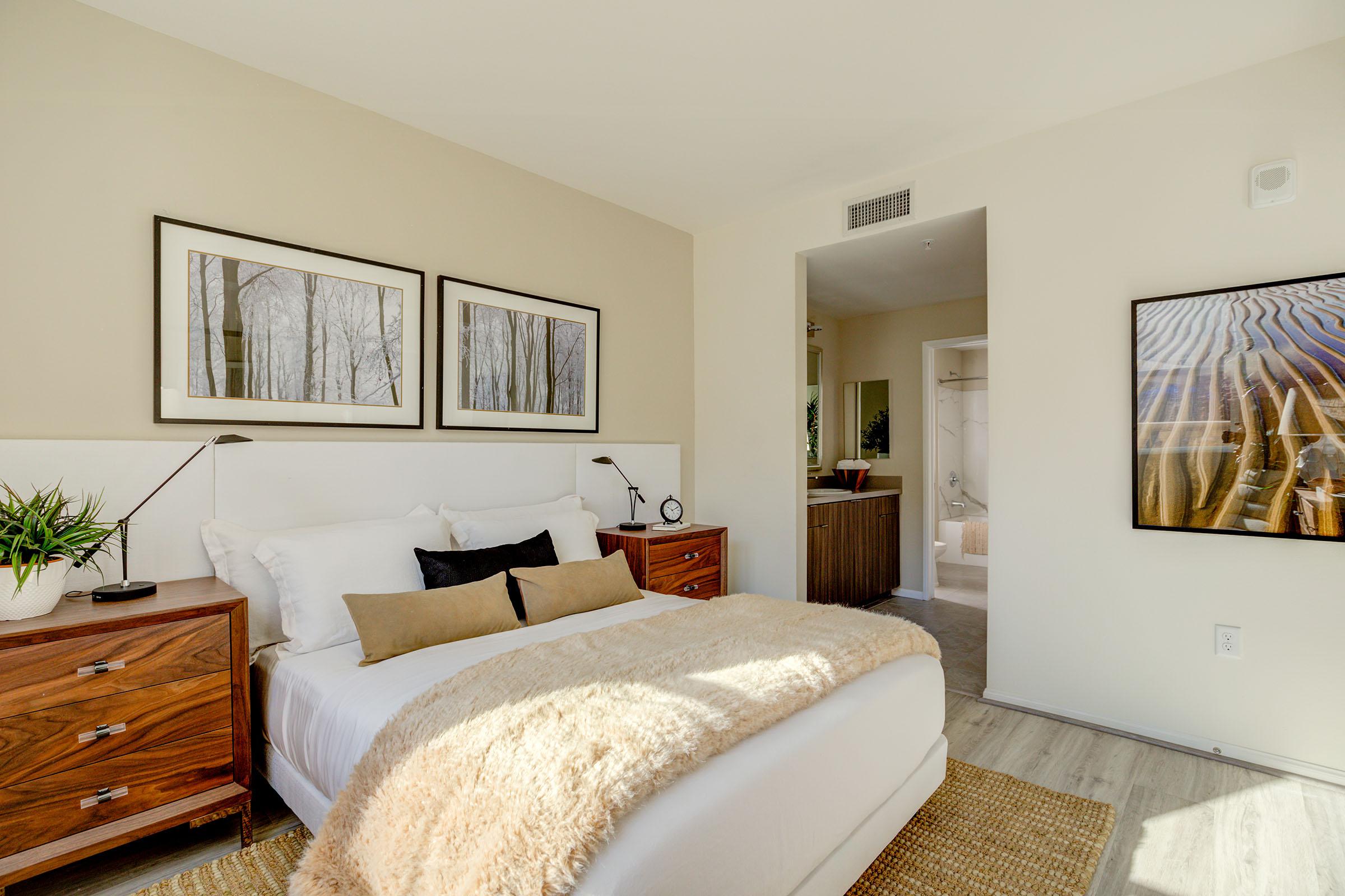 a living room with a bed and a flat screen tv