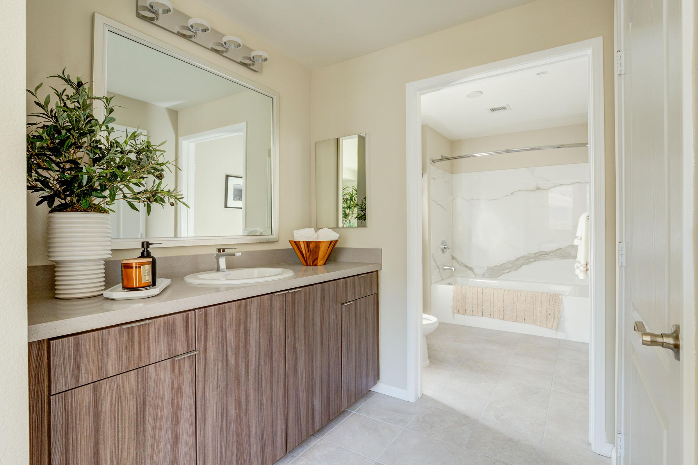 a kitchen with a sink and a mirror