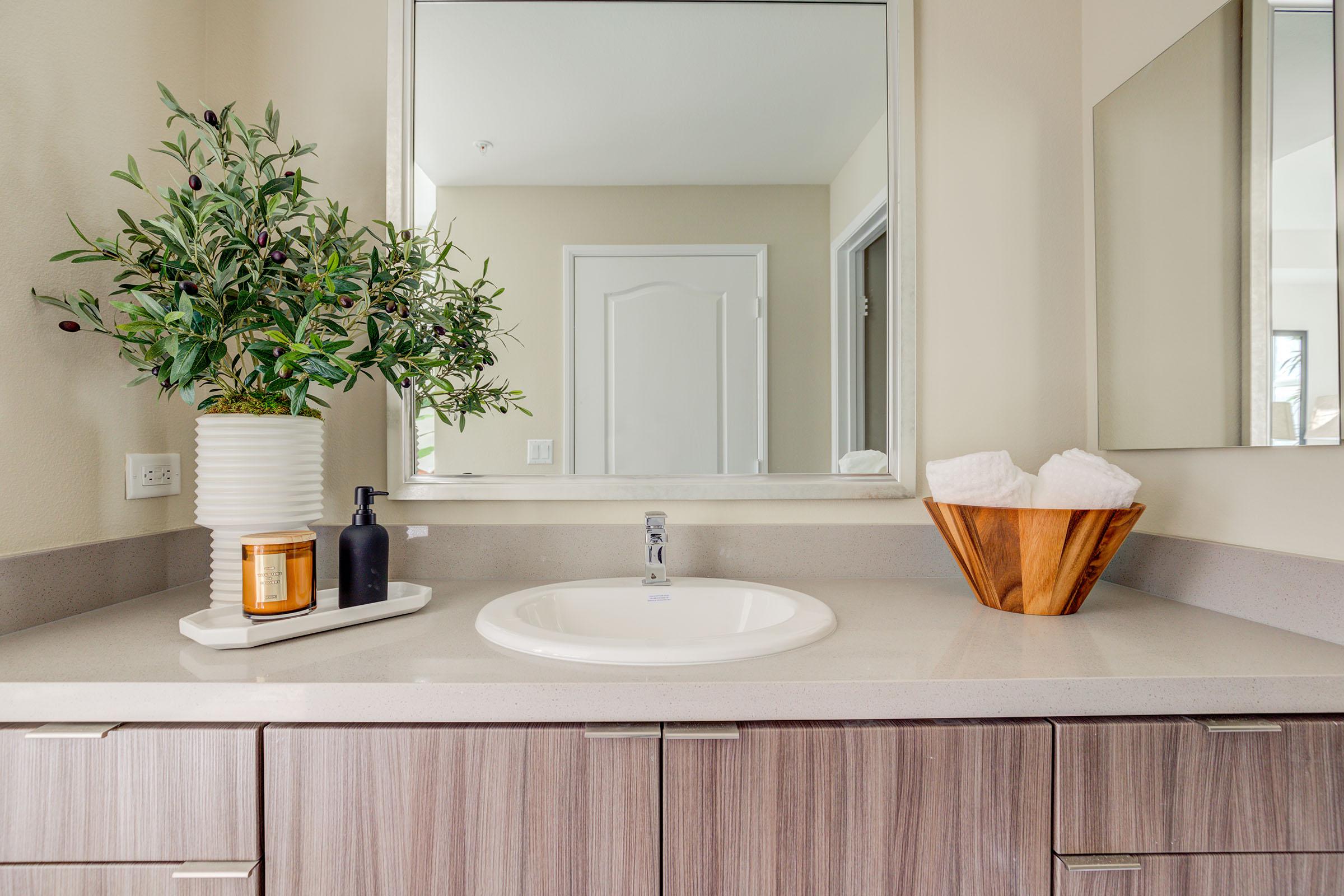 a kitchen with a sink and a mirror