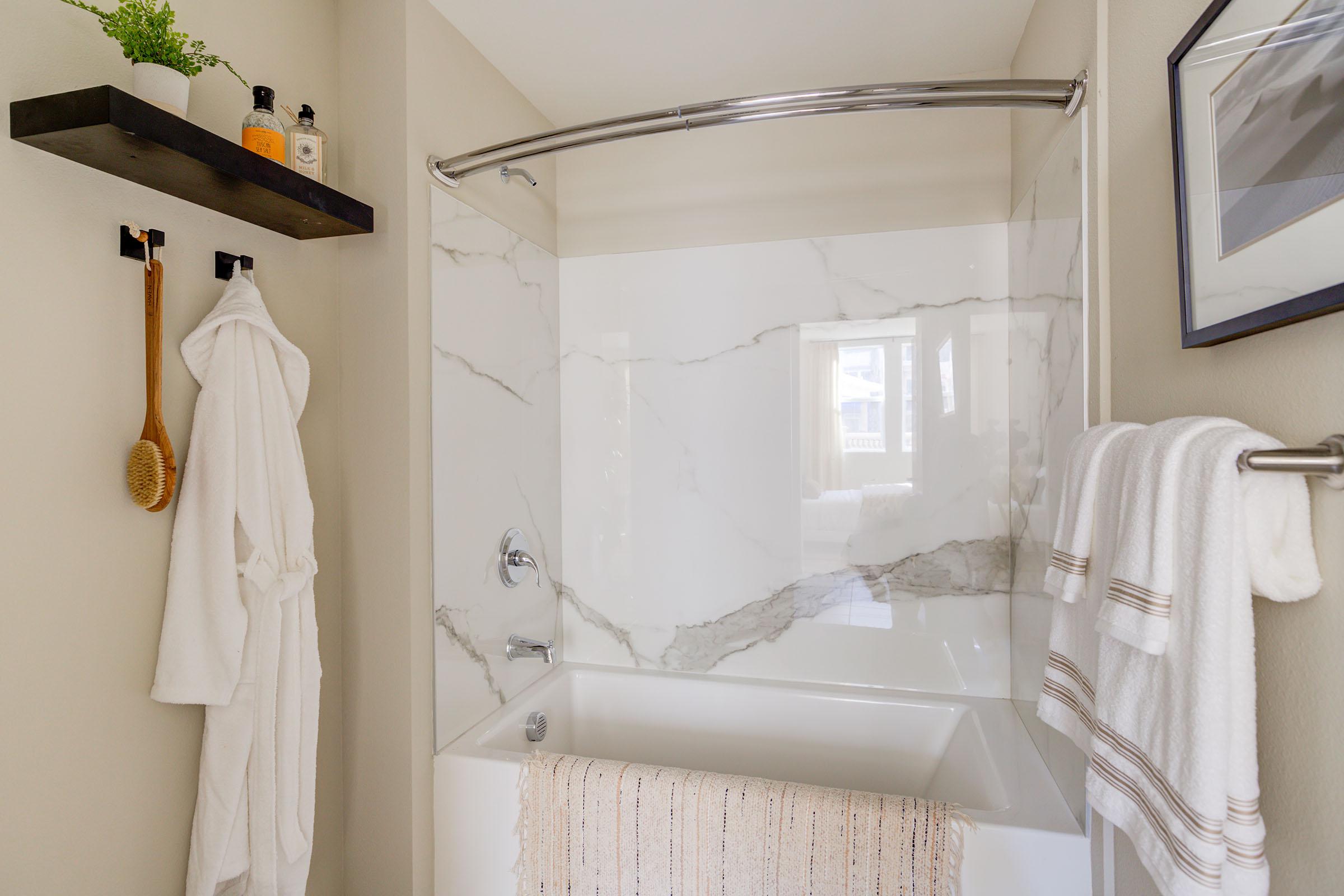 a shower with a towel hanging on the wall