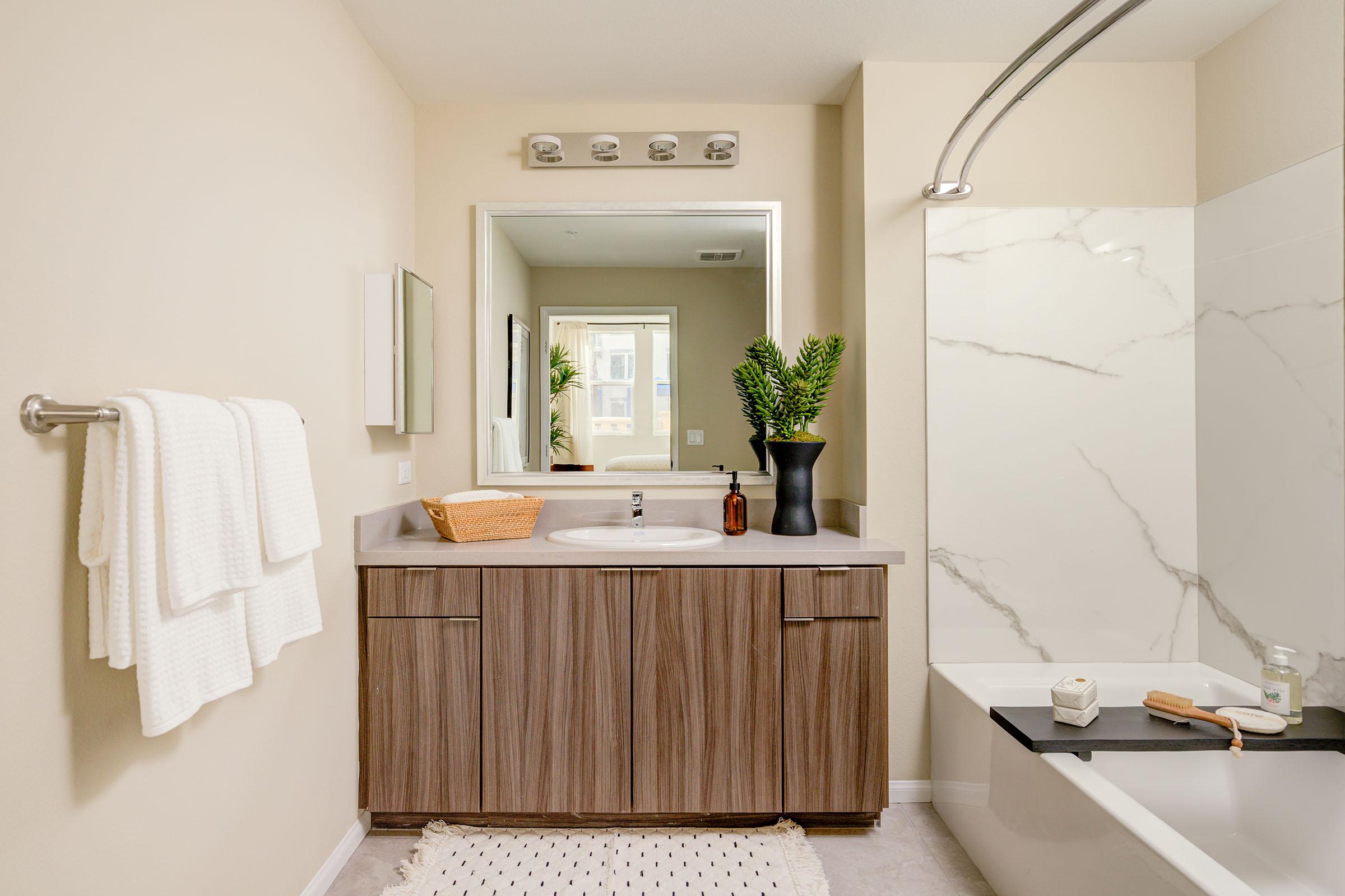 a living area with a sink and a mirror