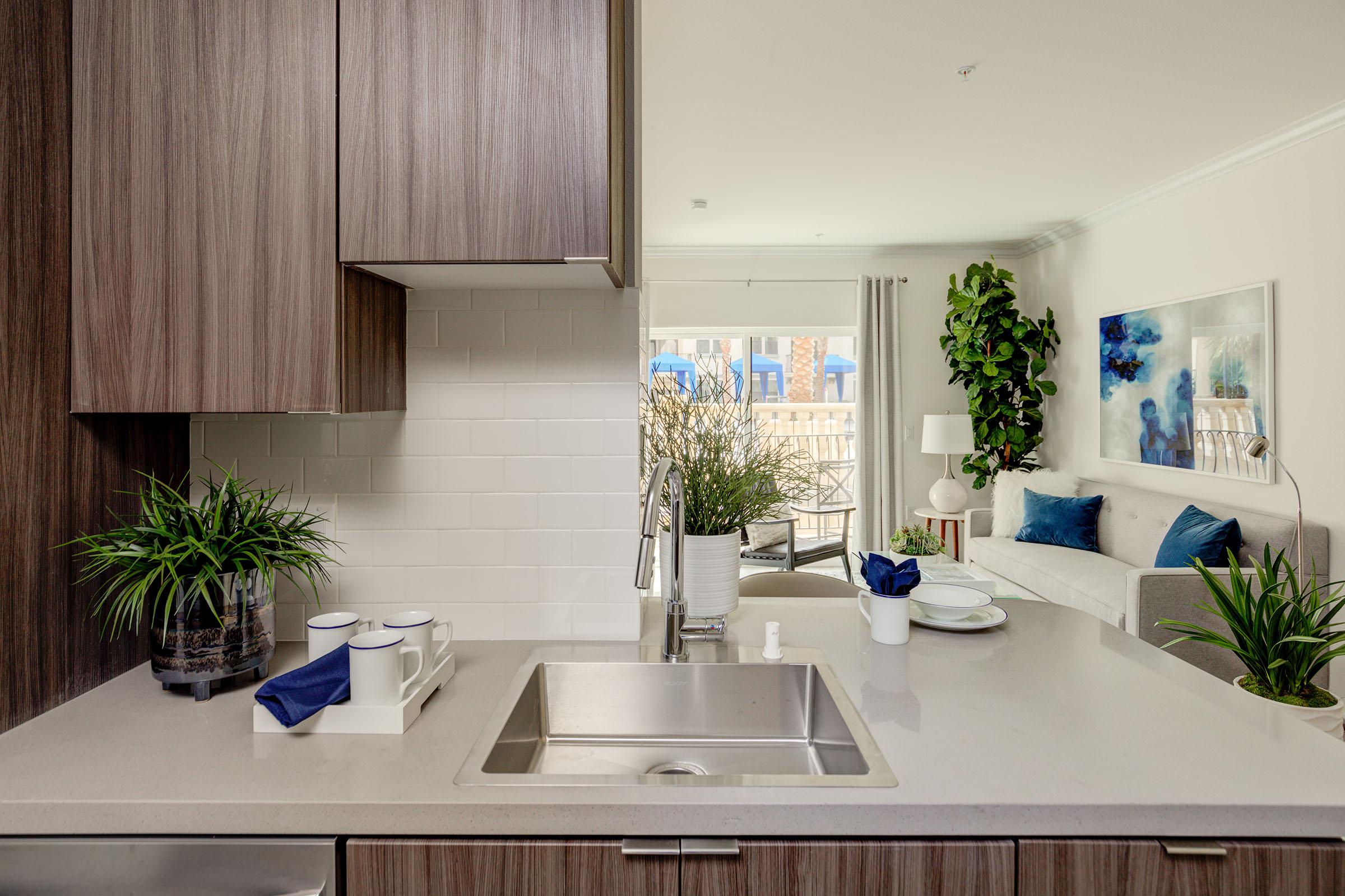 a kitchen with a sink and a vase of flowers on a table