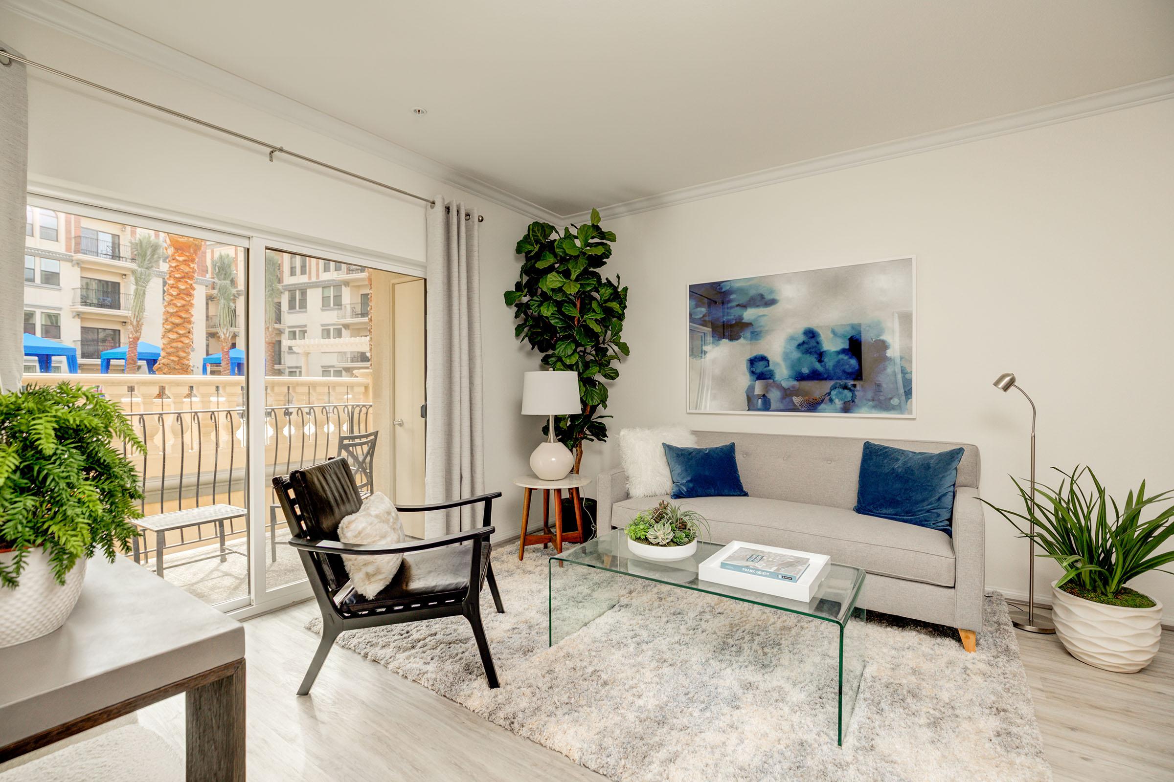 a living room filled with furniture and a large window