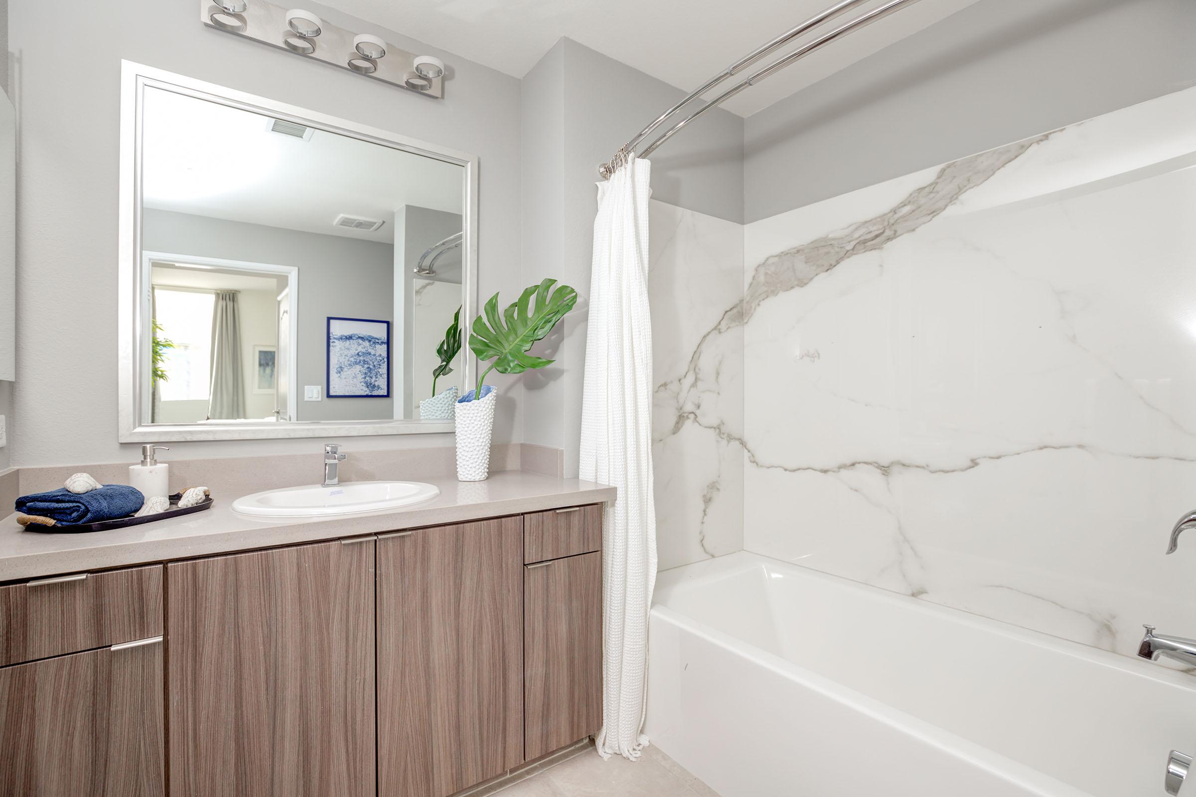 a kitchen with a sink and a mirror