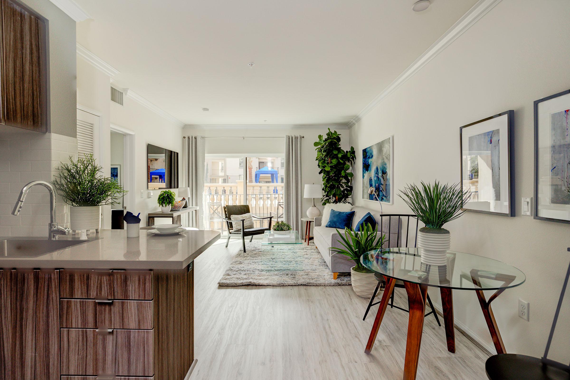 a living room filled with furniture and a large window