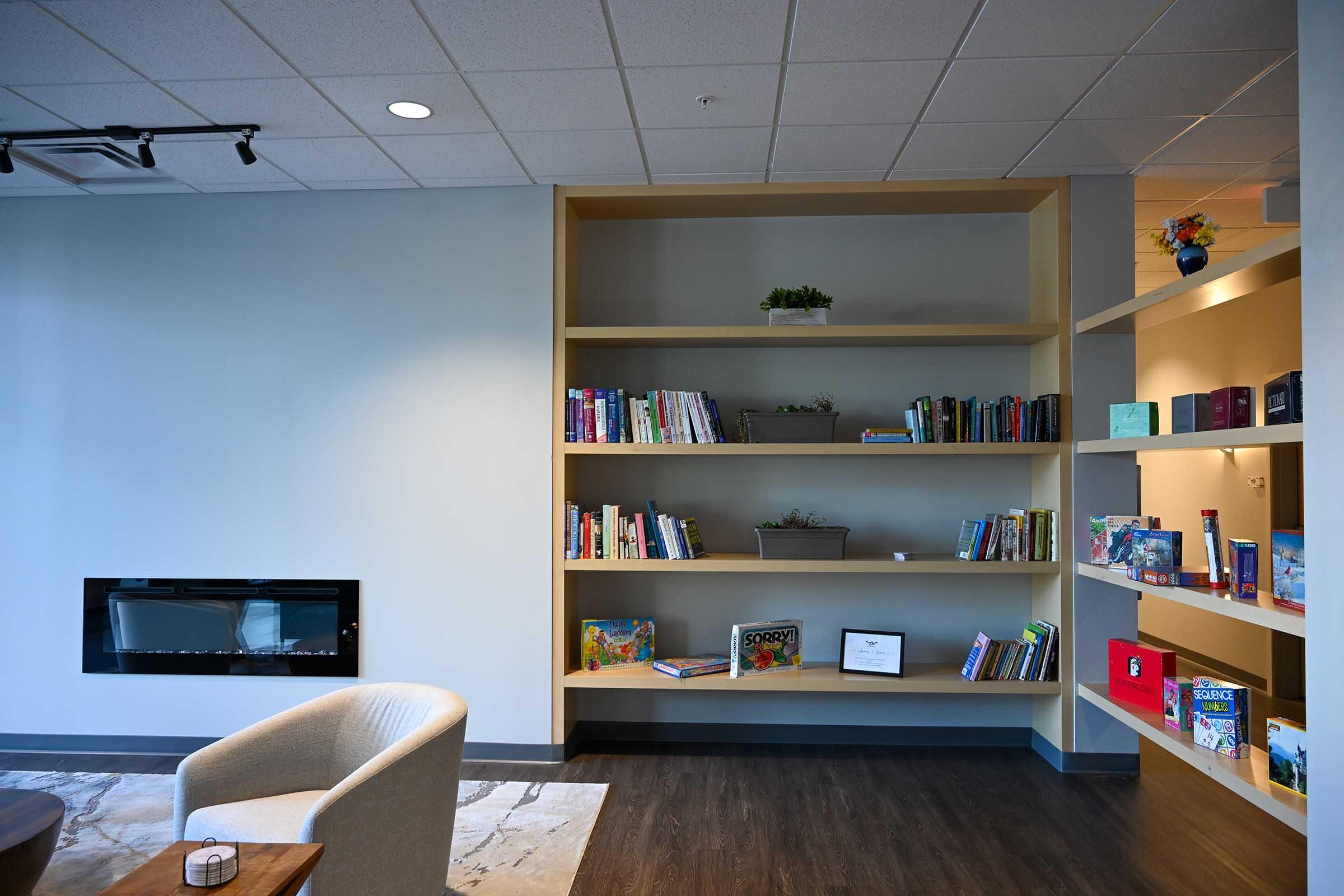 a flat screen tv sitting on top of a book shelf