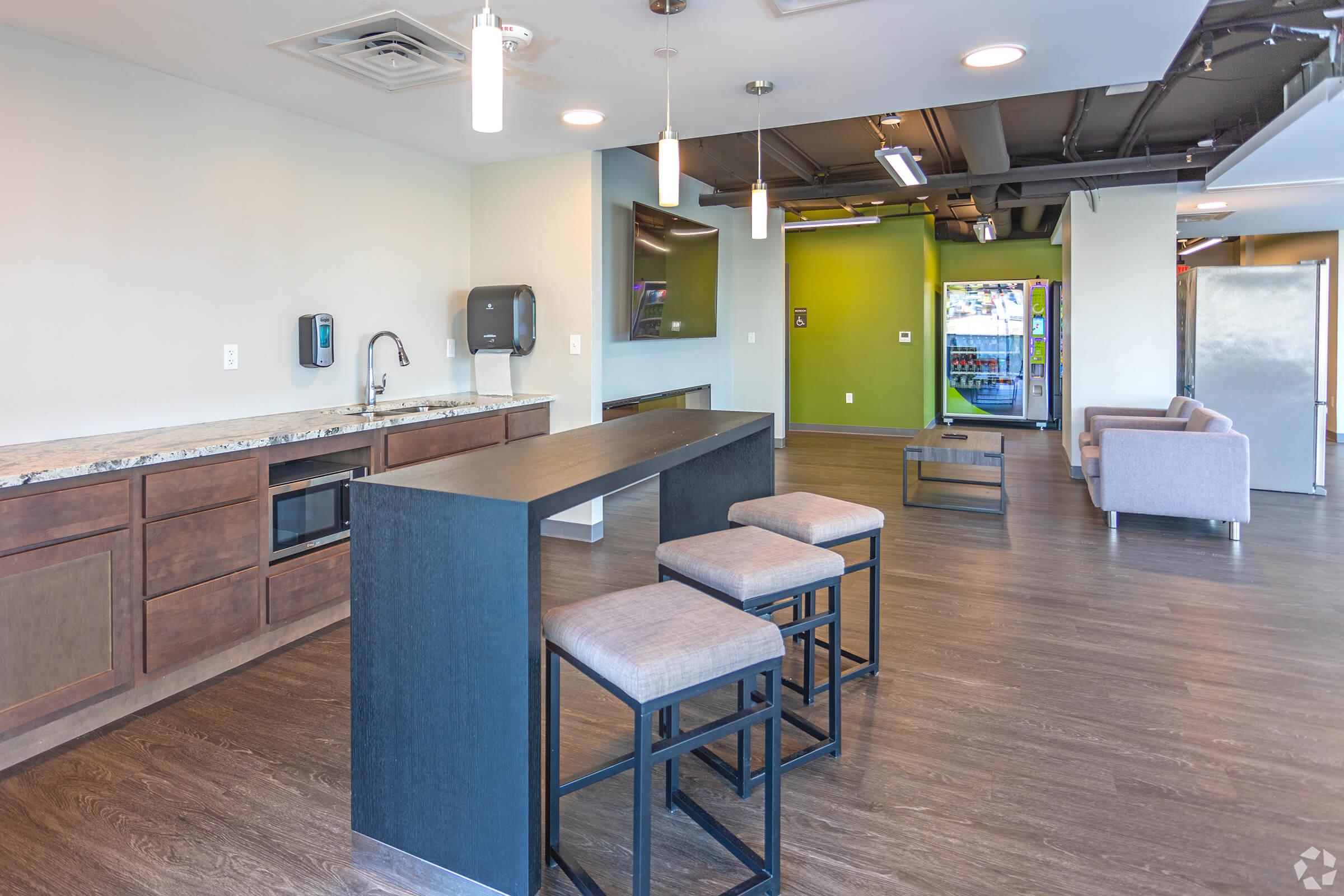 a kitchen with a table and chairs in a room