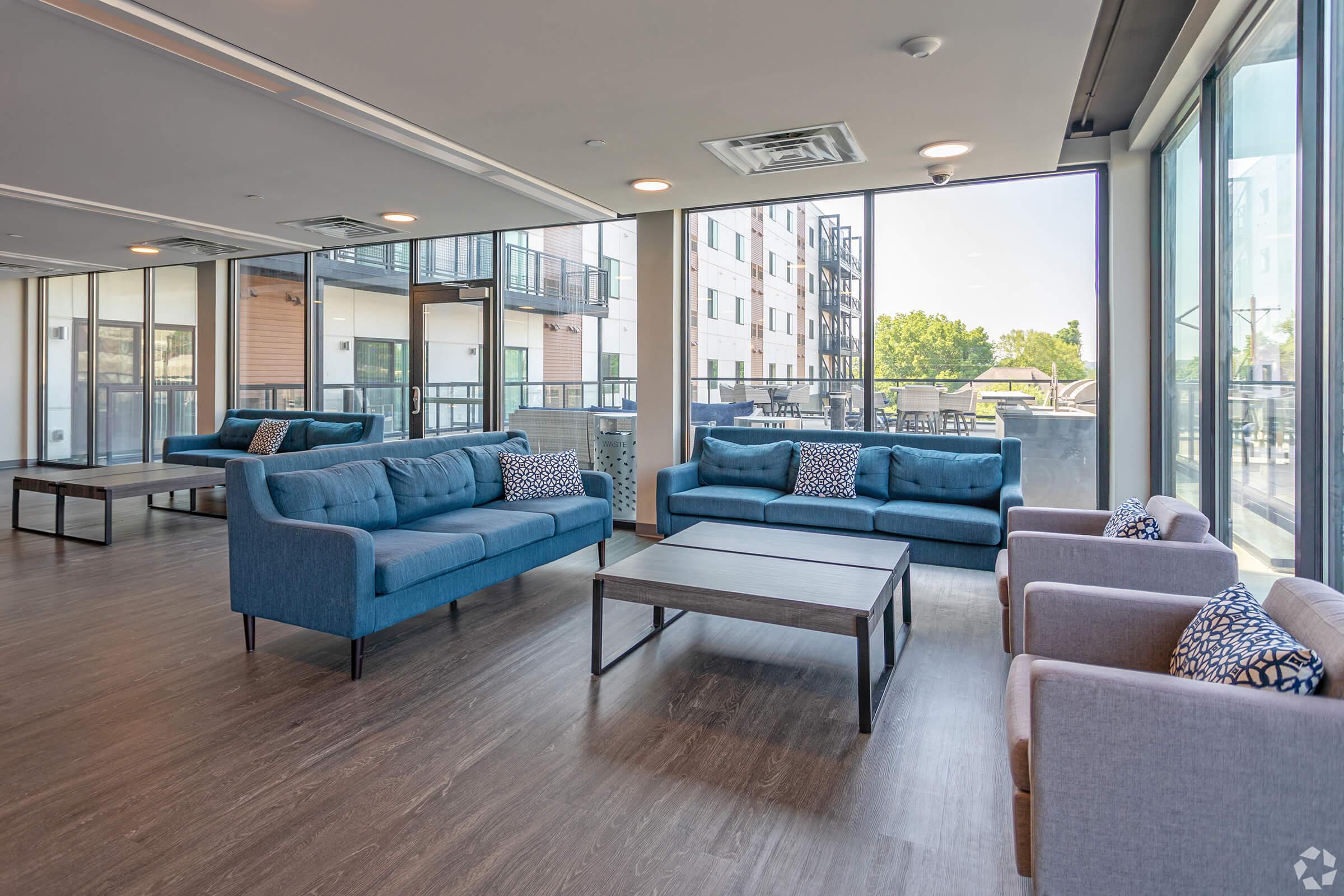 a living room filled with furniture and a large window