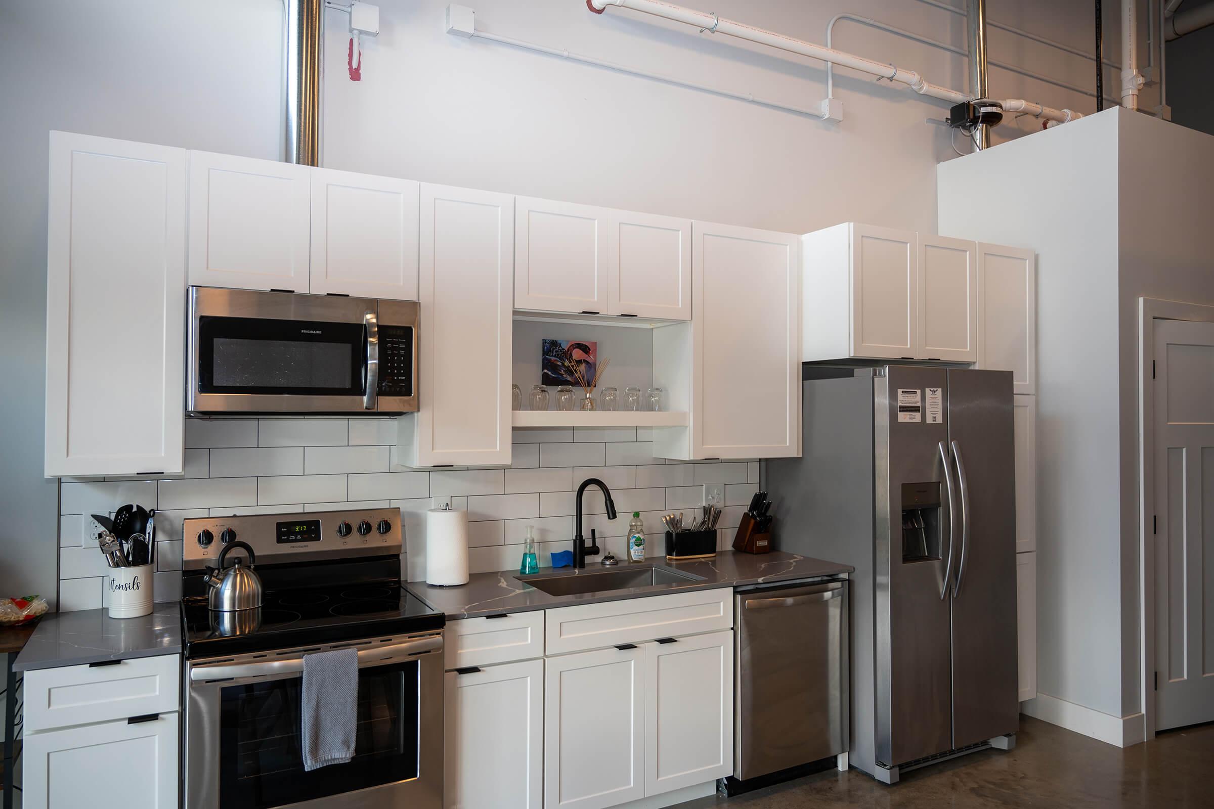 a kitchen with a sink and a refrigerator