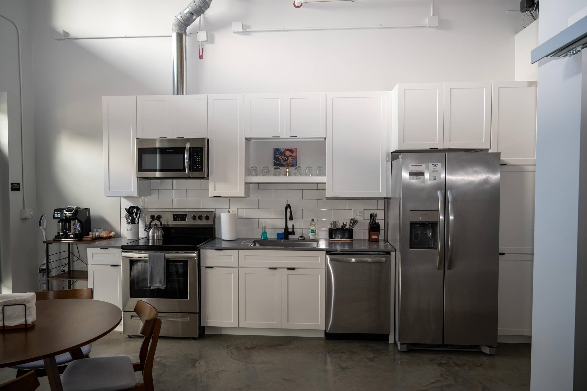 a kitchen with a sink and a refrigerator