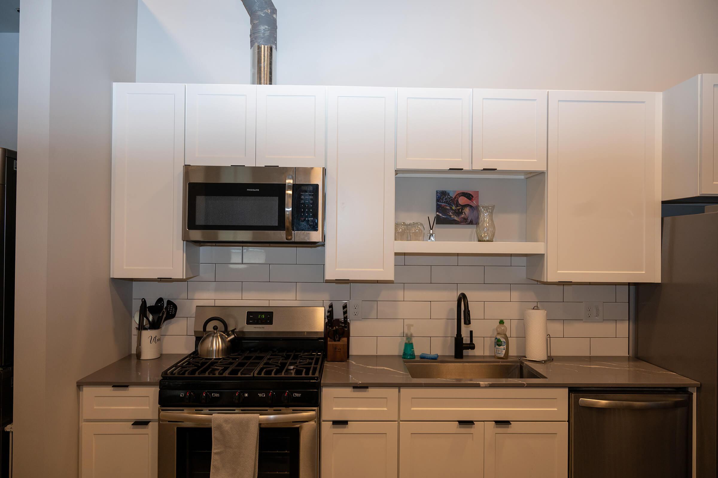 a stove top oven sitting inside of a kitchen