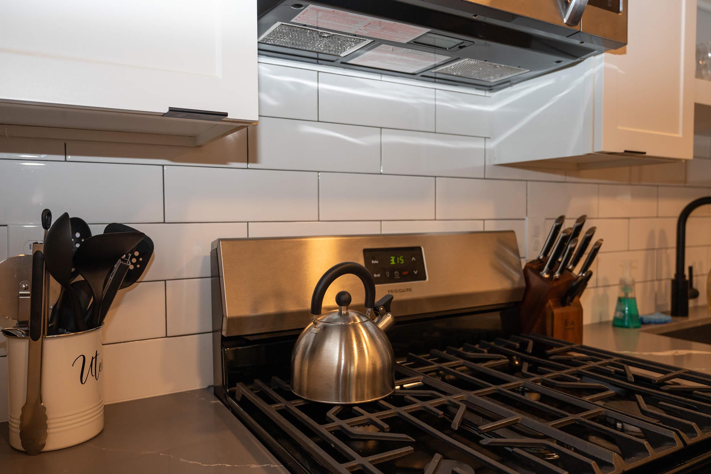 a stove top oven sitting inside of a kitchen