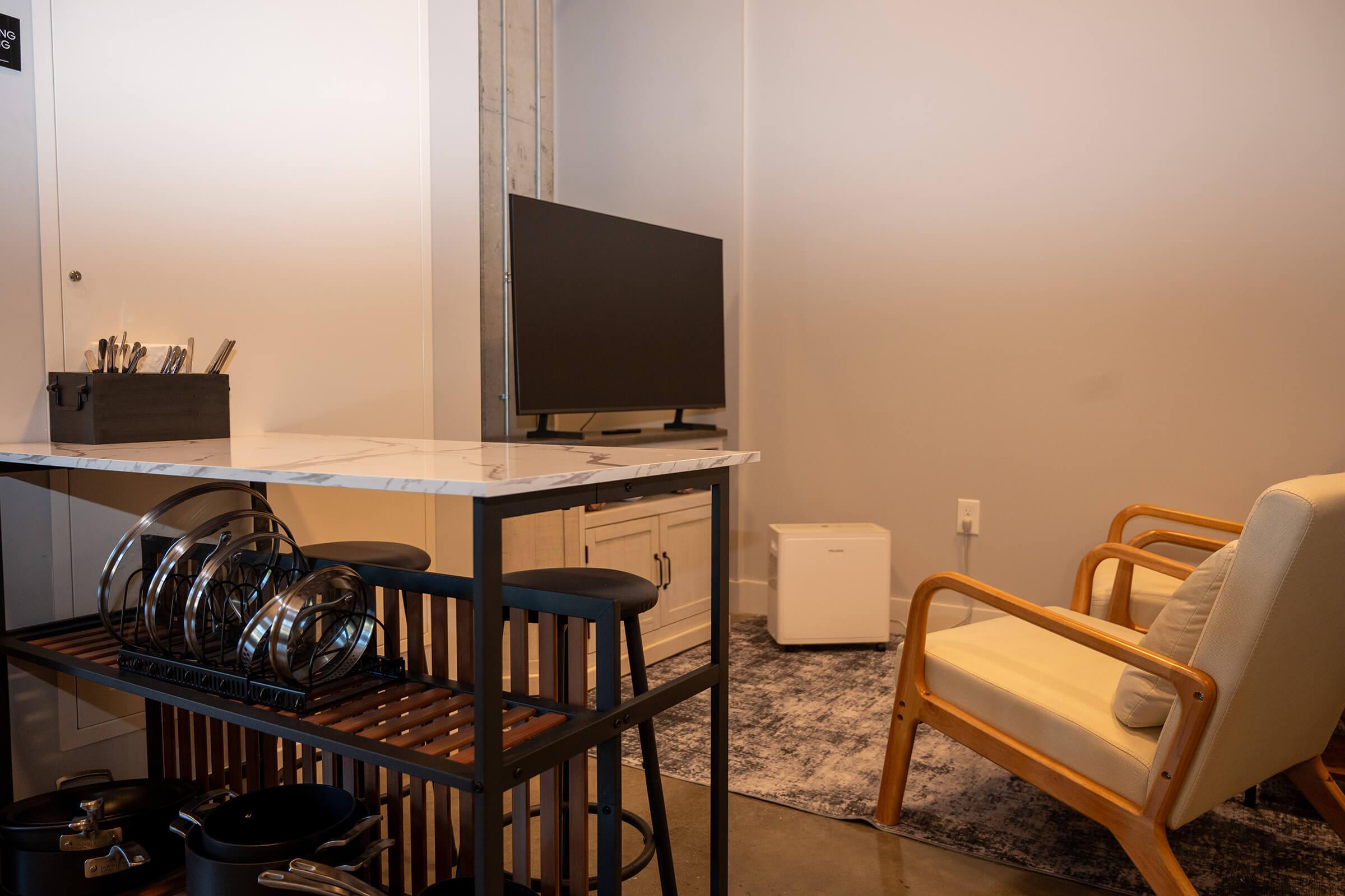 a kitchen with a table and a chair in a room