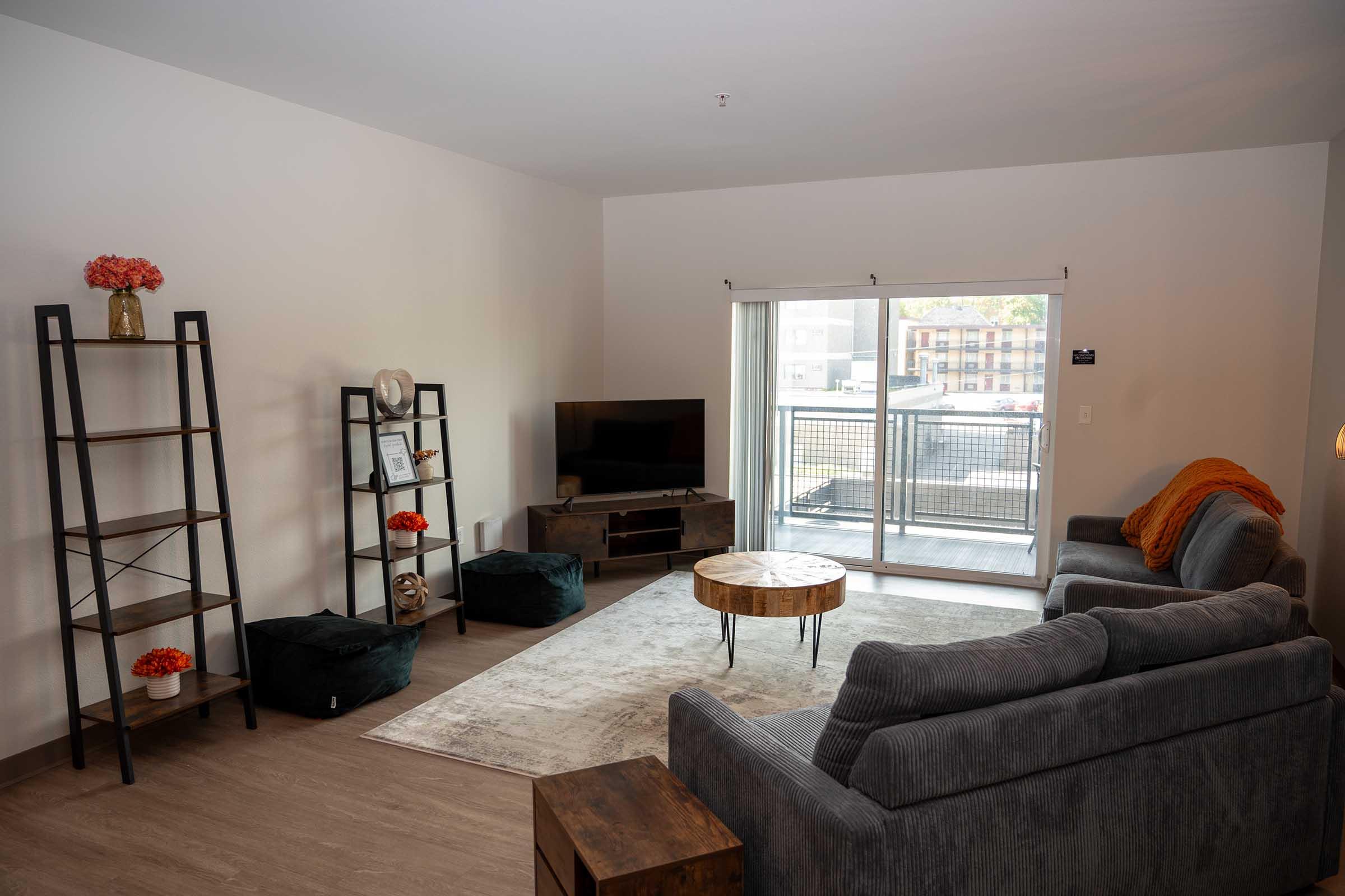 a living room filled with furniture and a flat screen tv