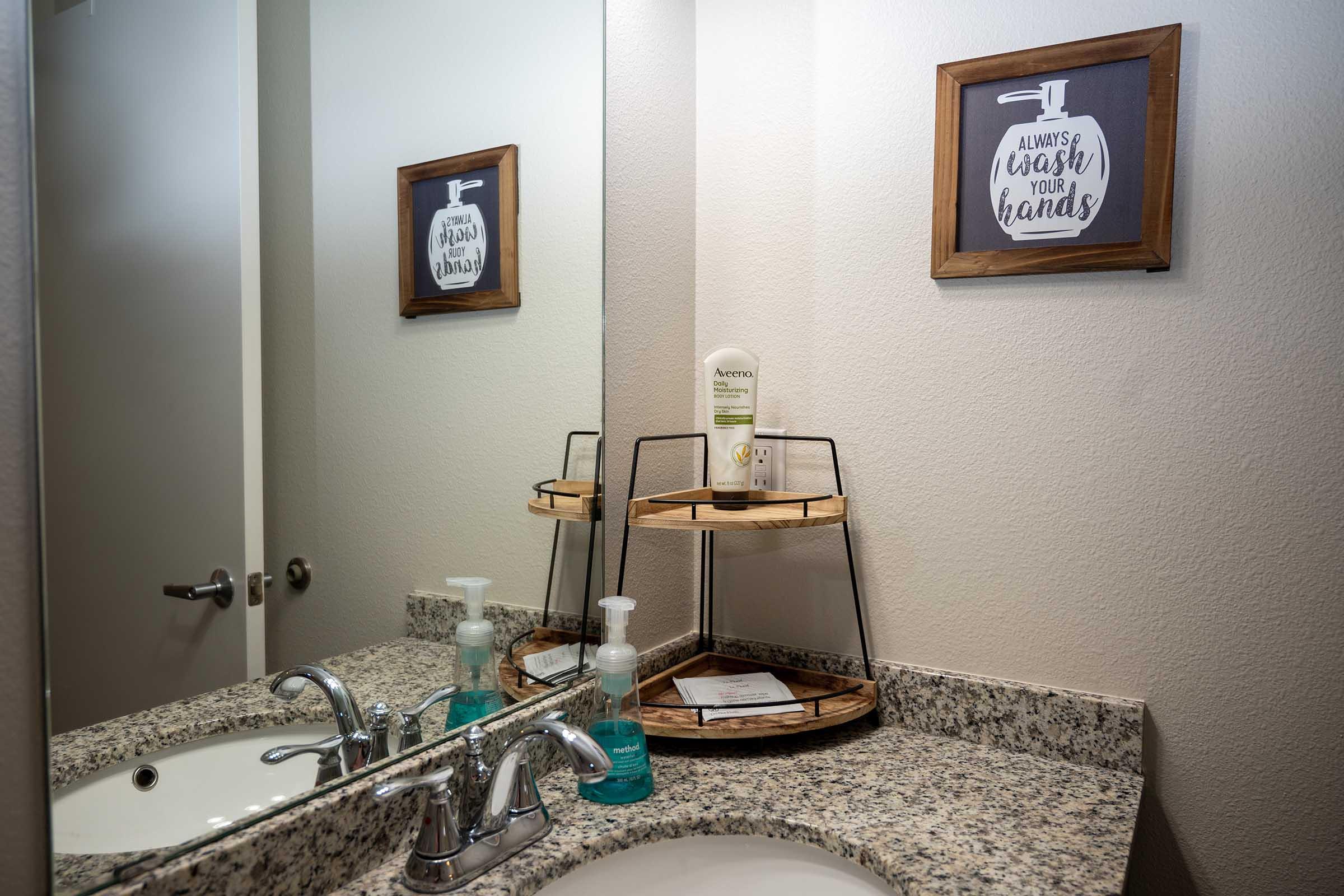 a room with a sink and a mirror