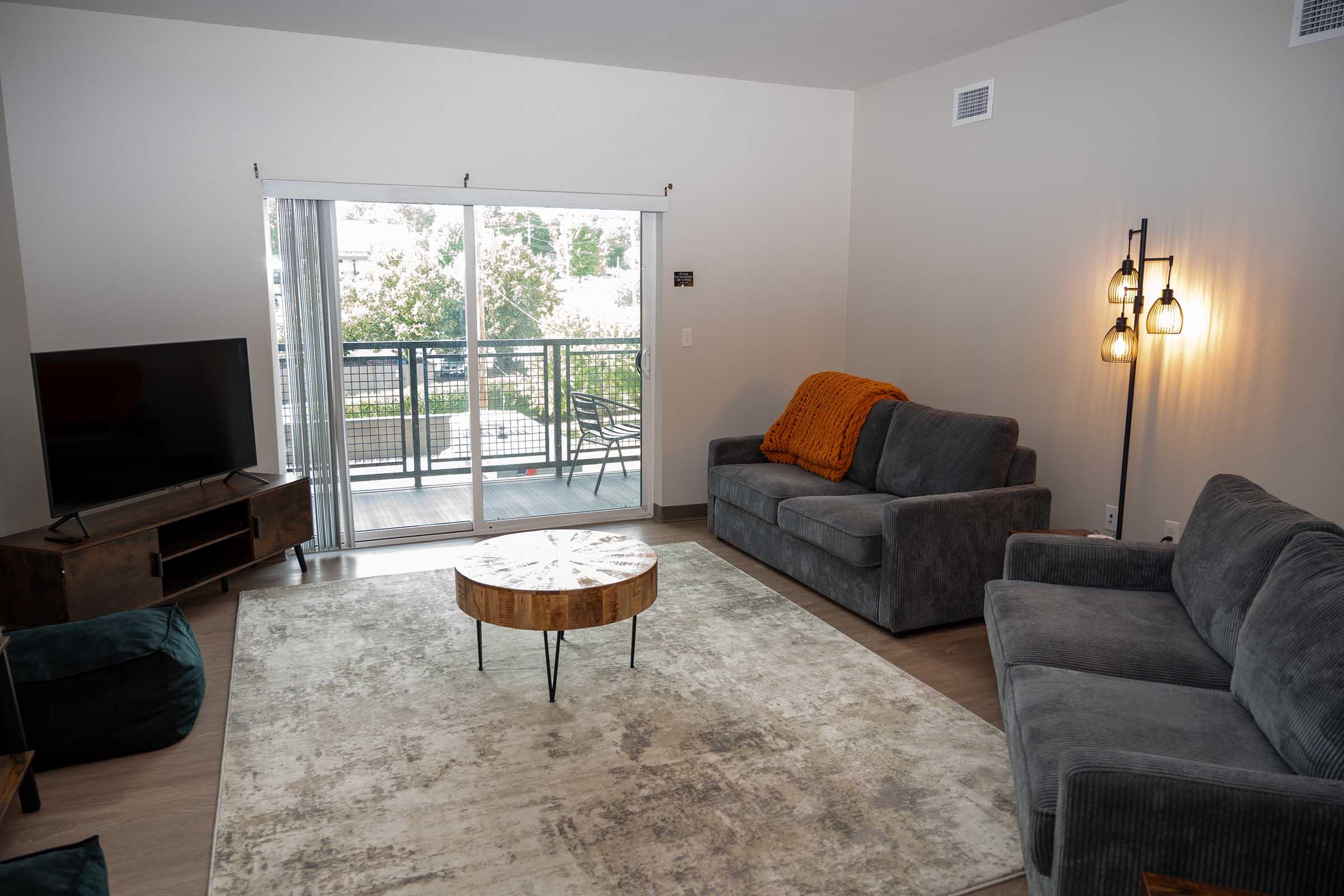 a living room filled with furniture and a large window