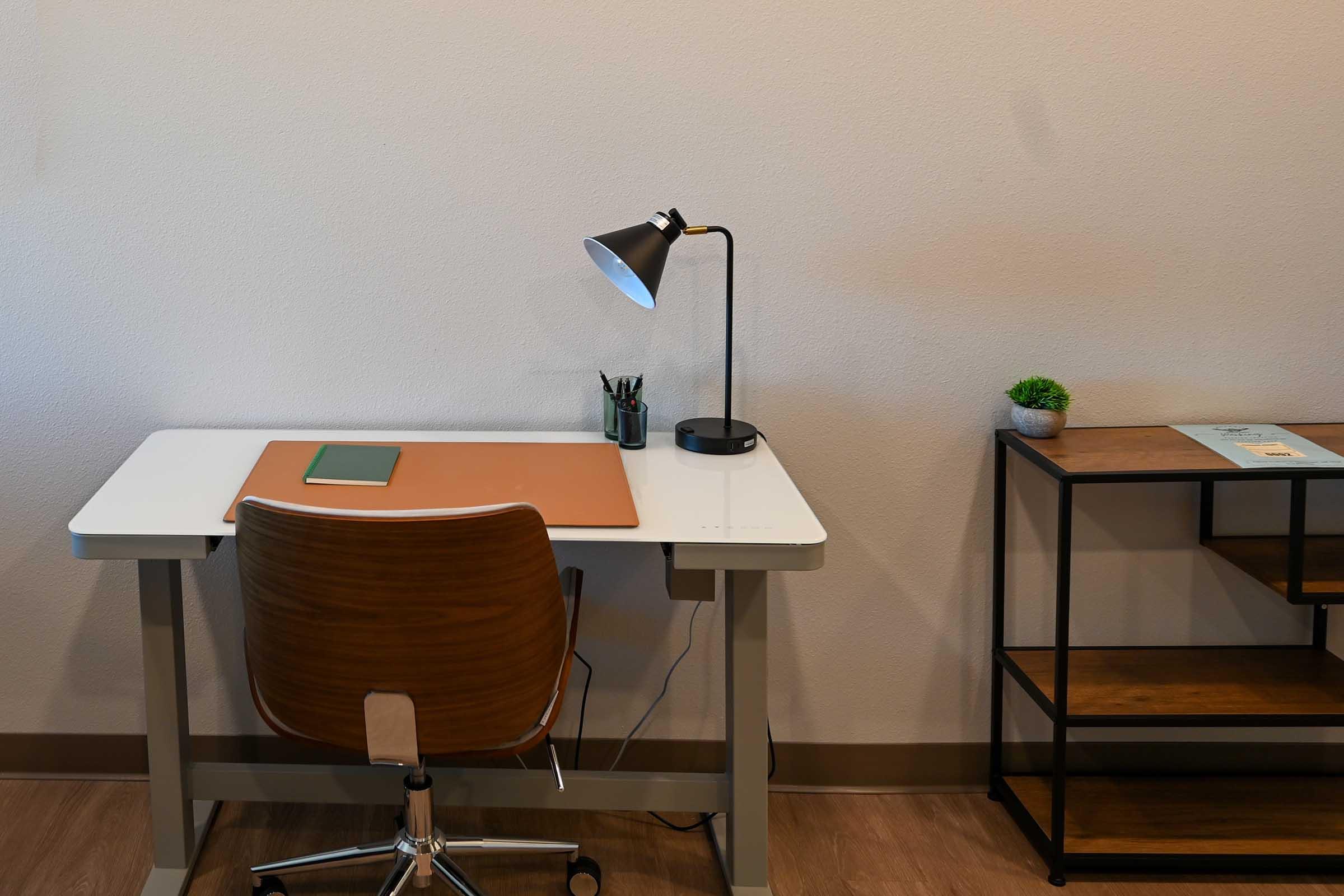 a desk with a chair in a room