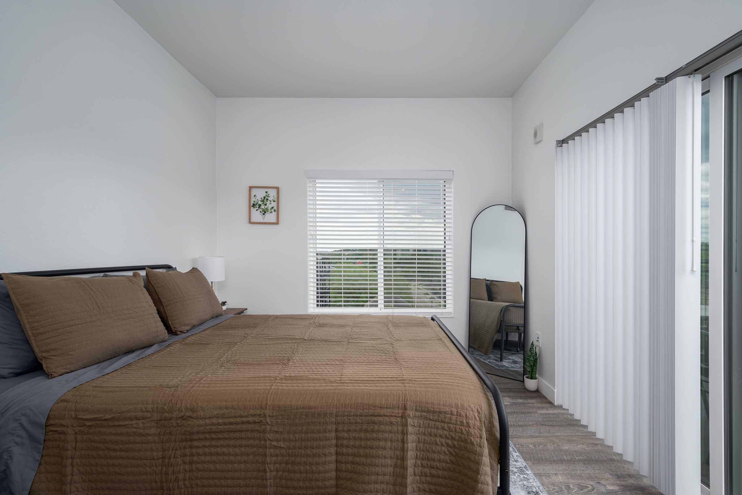 a bedroom with a large bed sitting in a room