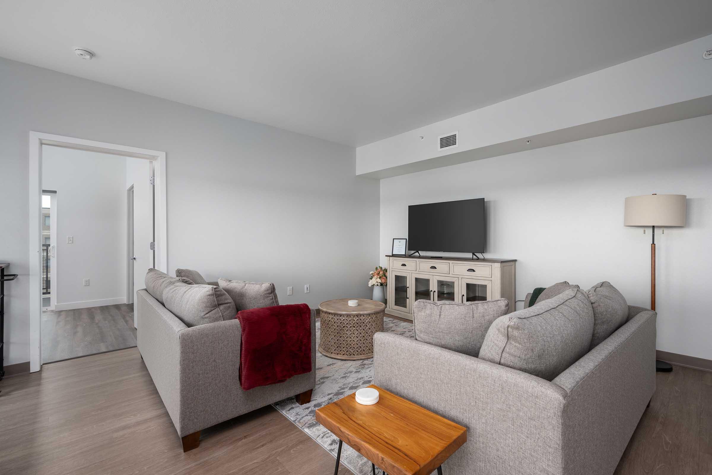 a living room filled with furniture and a flat screen tv