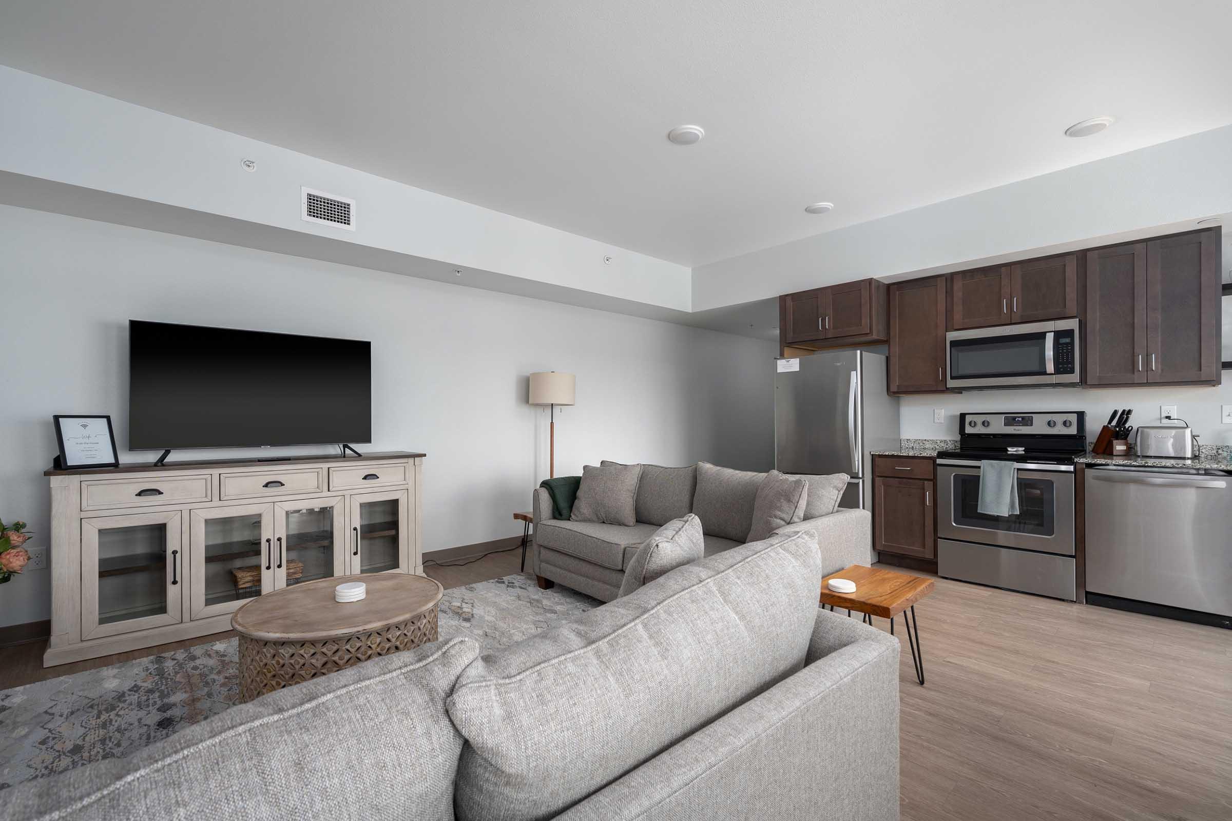 a living room filled with furniture and a flat screen tv