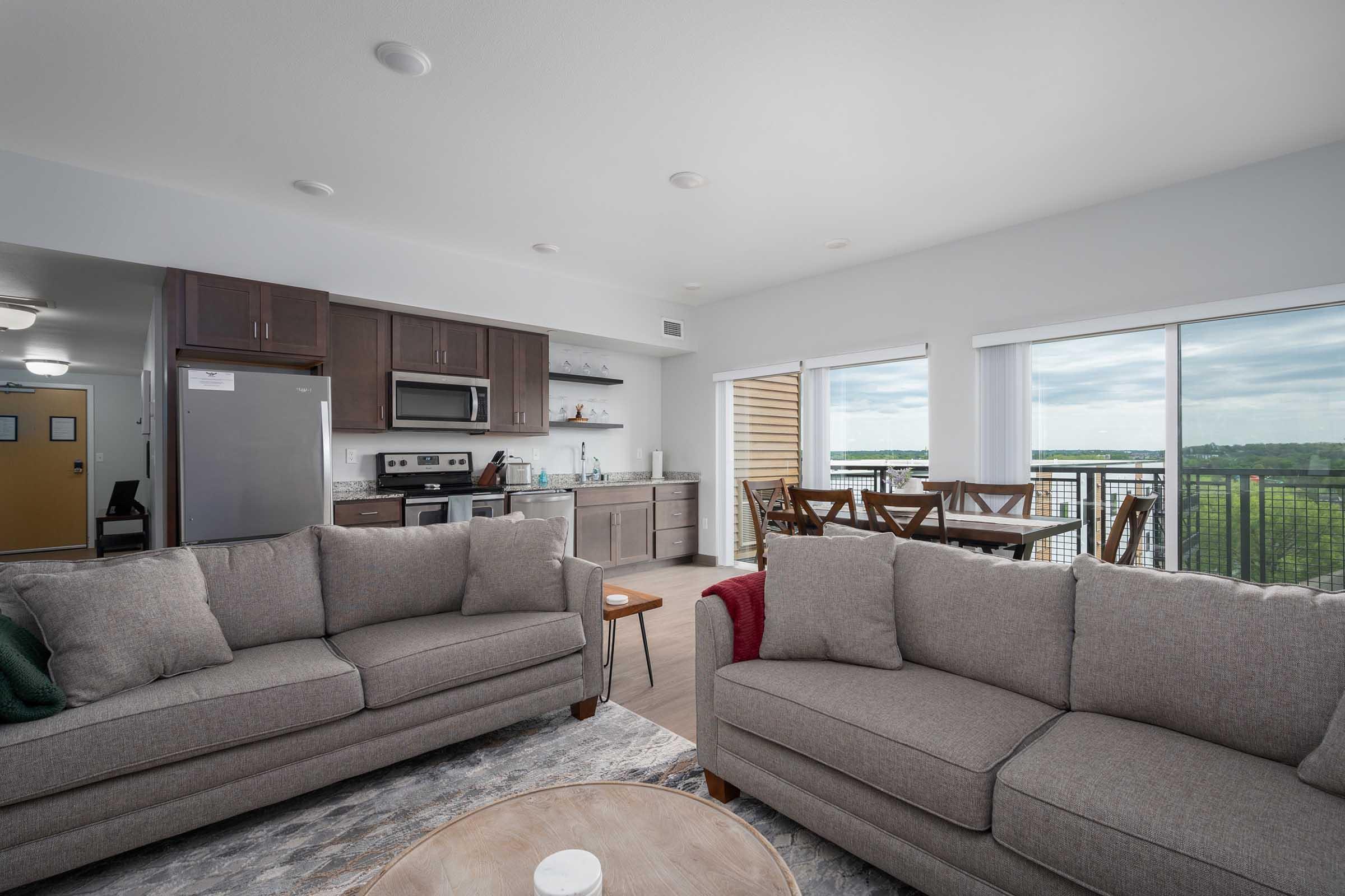 a living room filled with furniture and a large window