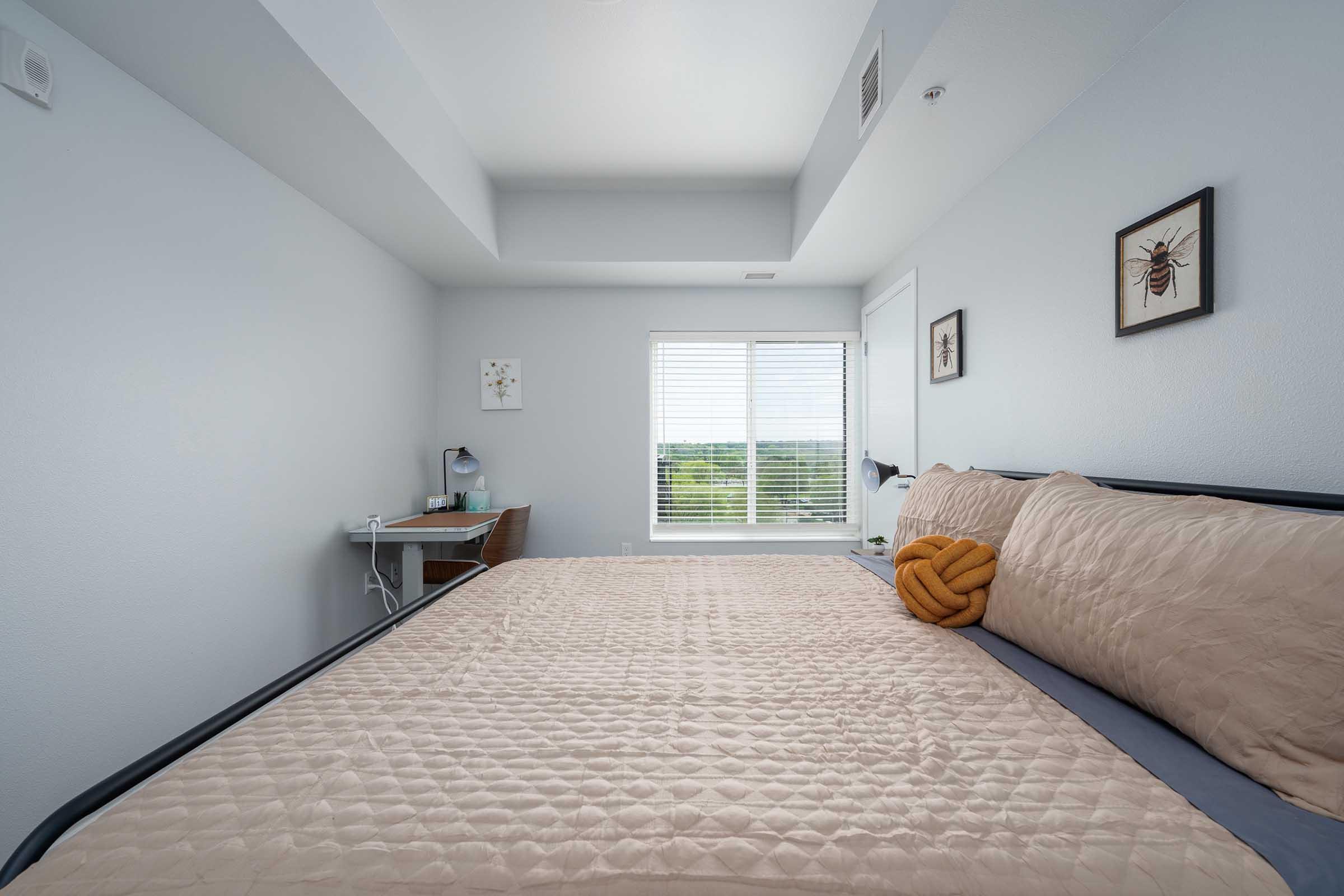 a bedroom with a large bed in a room