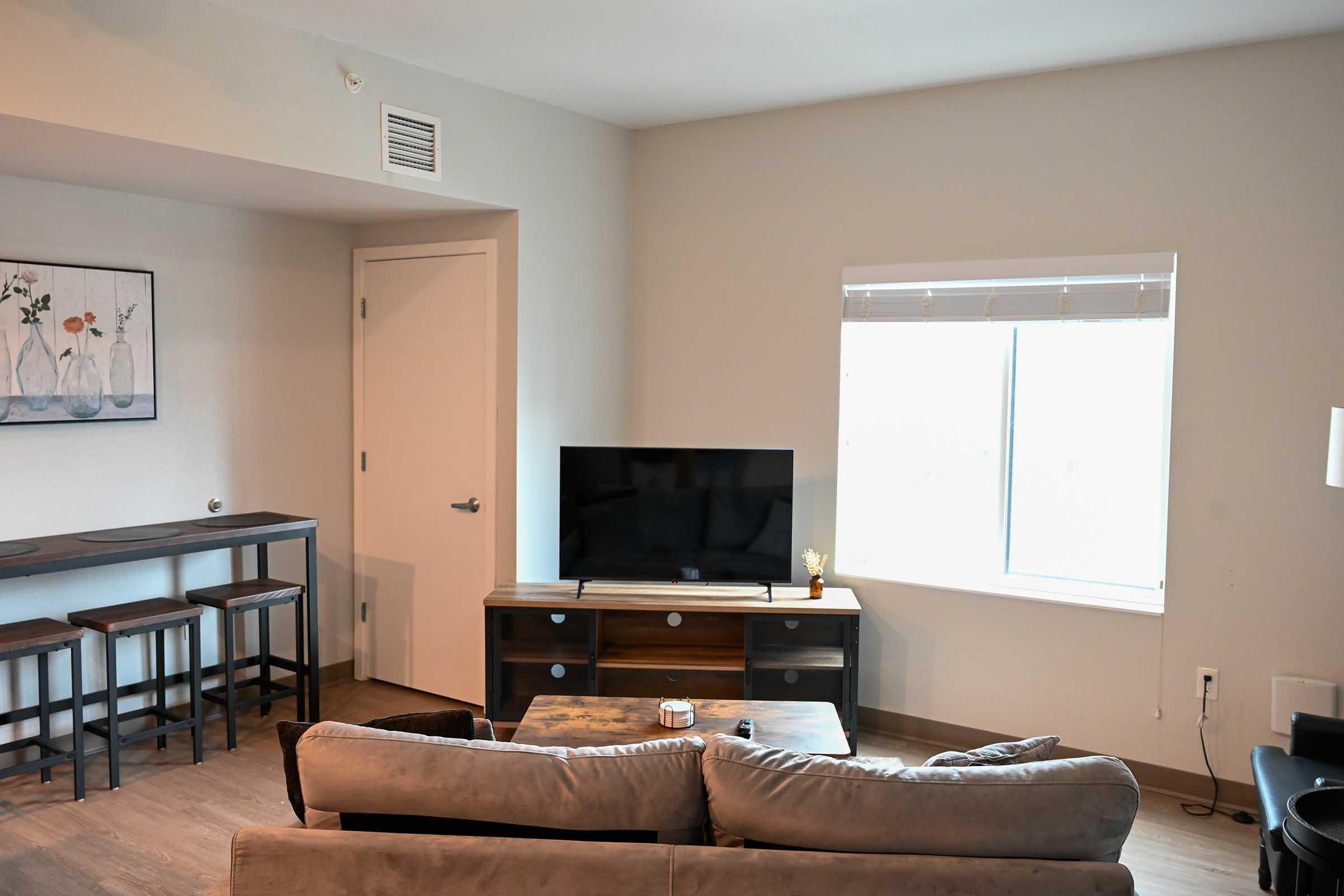 a living room filled with furniture and a flat screen tv