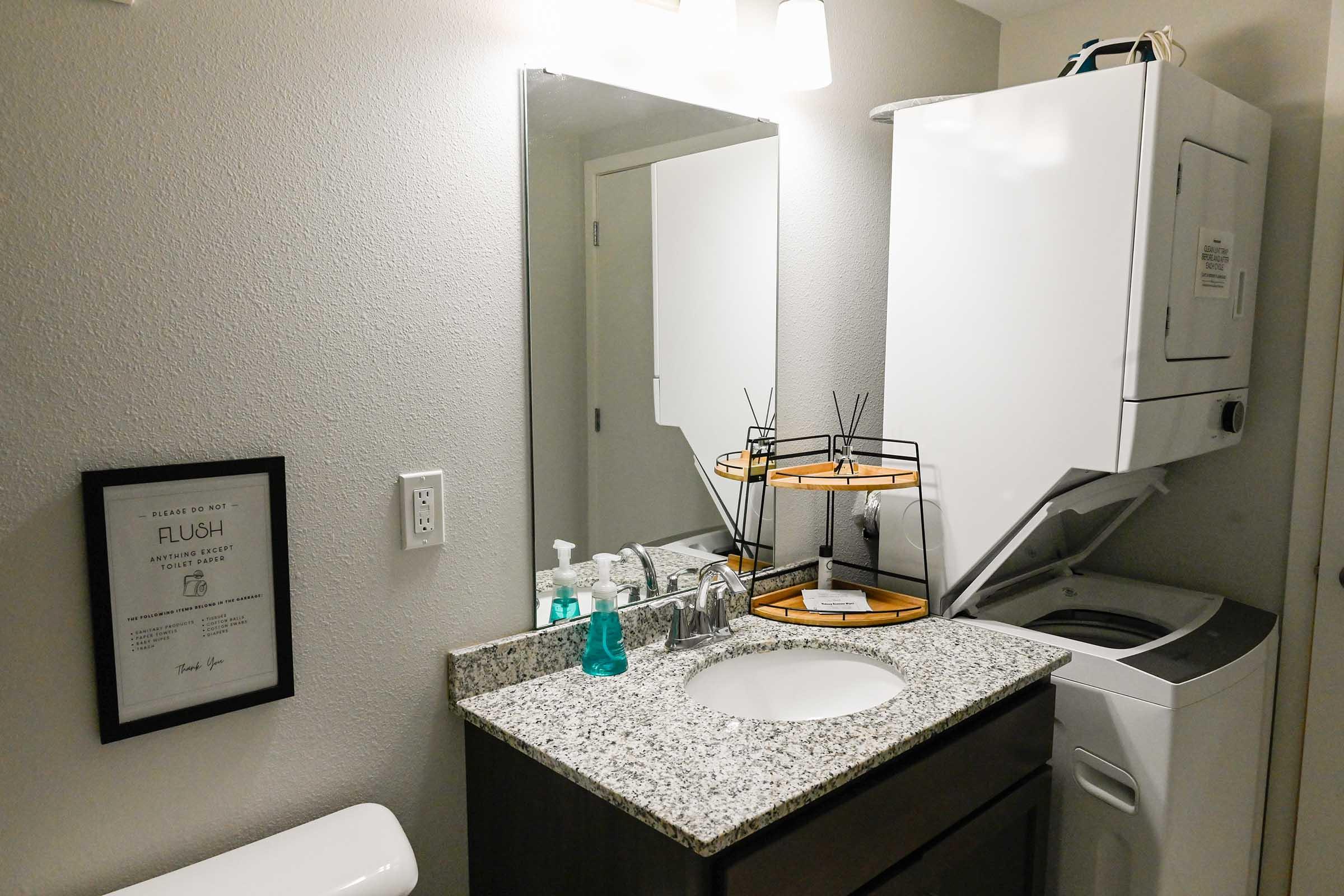 a kitchen with a sink and a mirror