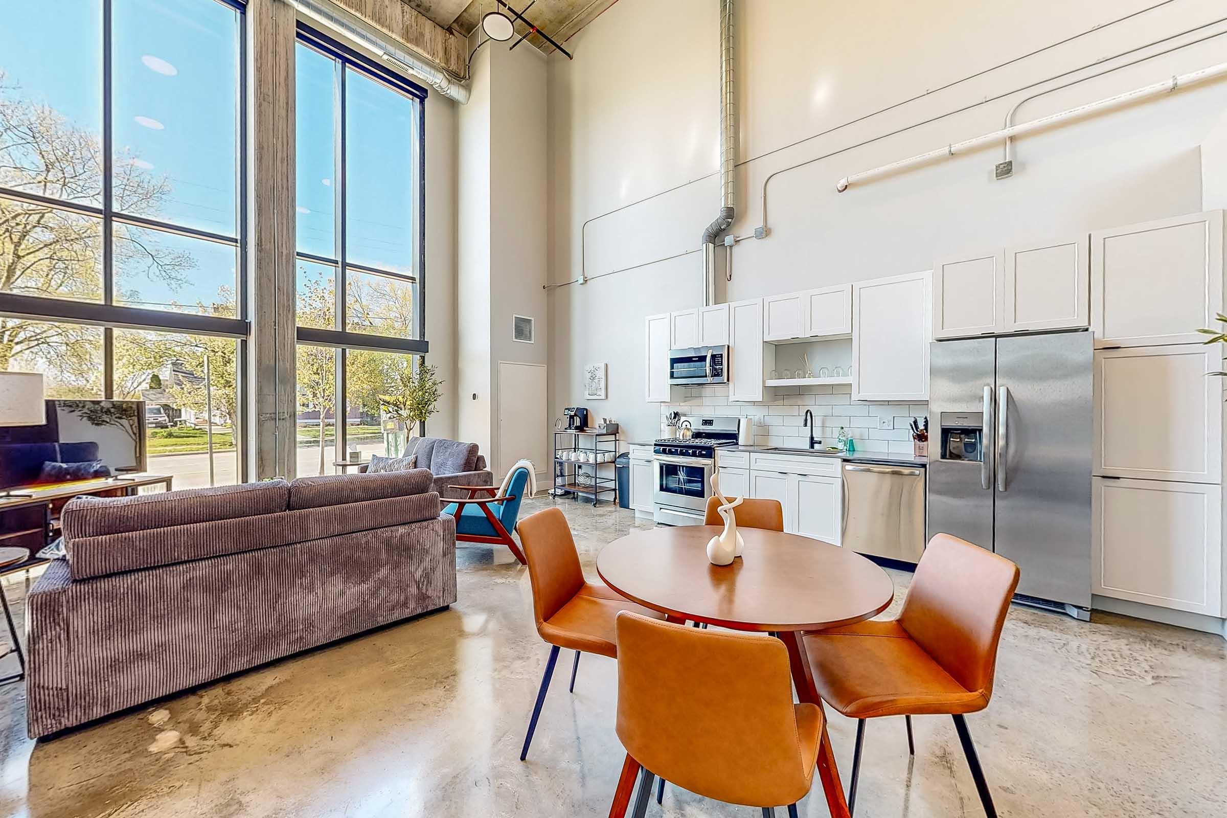 a living room filled with furniture and a large window