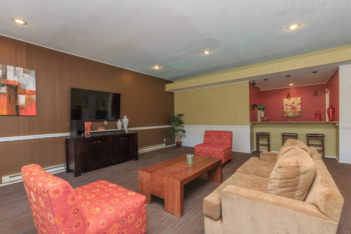 a living room filled with furniture and a flat screen tv