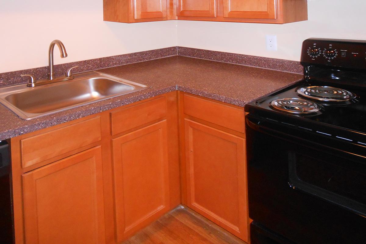 a black stove top oven sitting inside of a kitchen