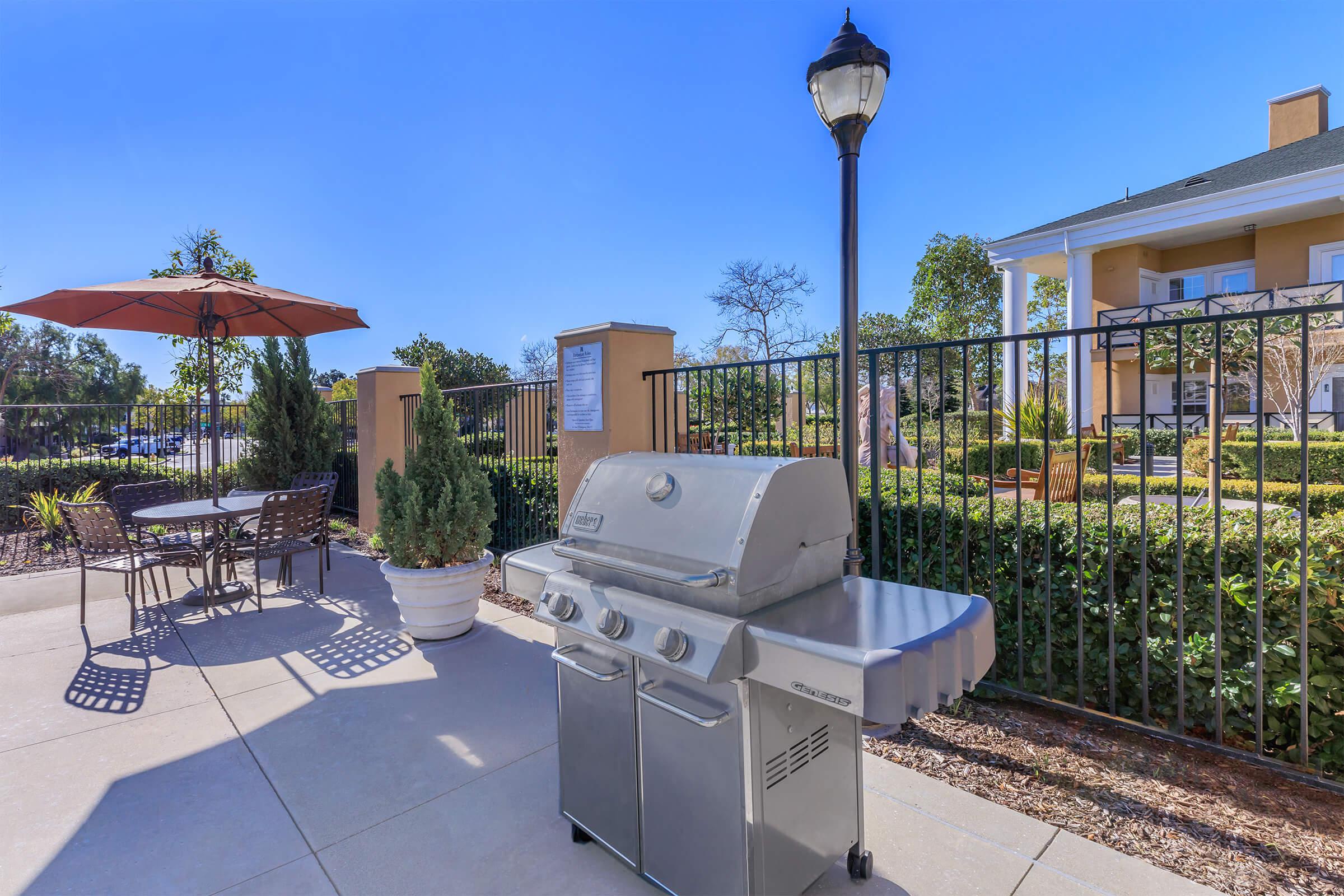 Stainless steel barbecue with a table and chairs