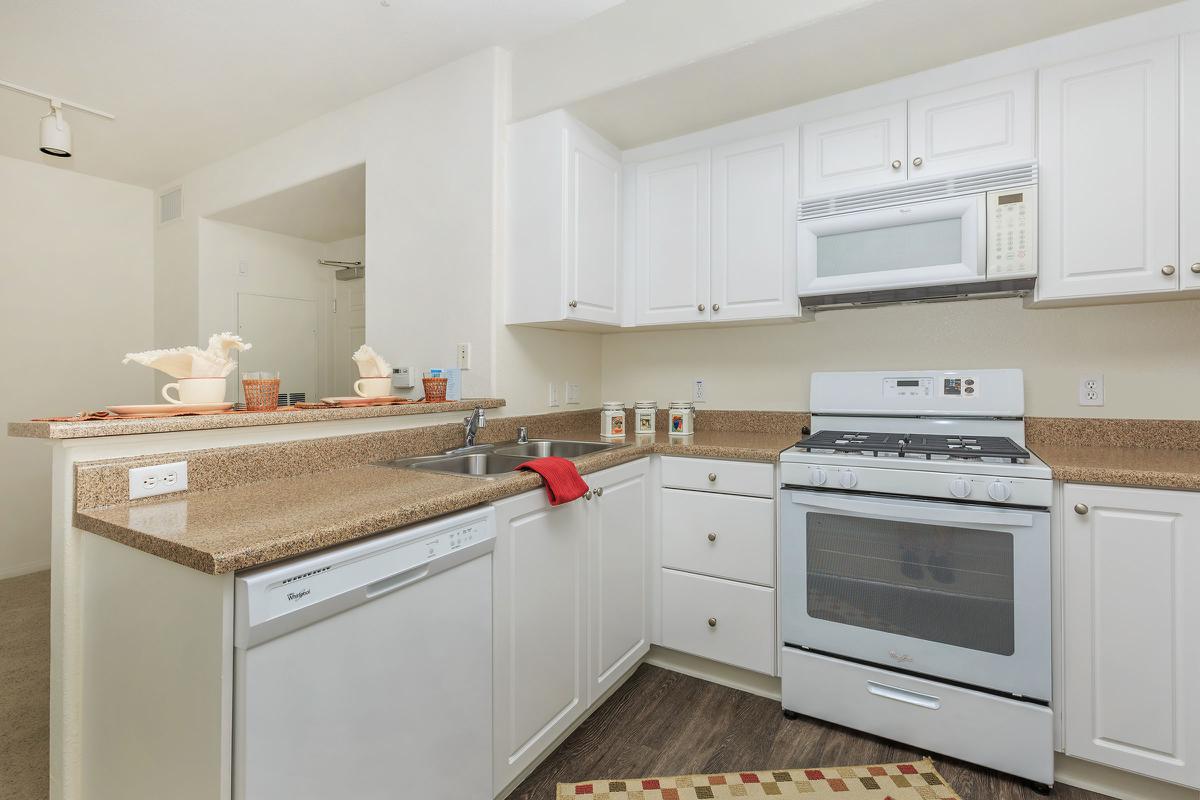 a white stove top oven sitting inside of a kitchen