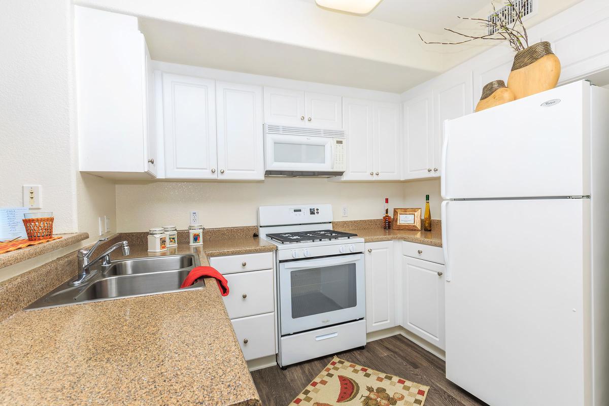 a kitchen with a stove top oven sitting inside of a refrigerator