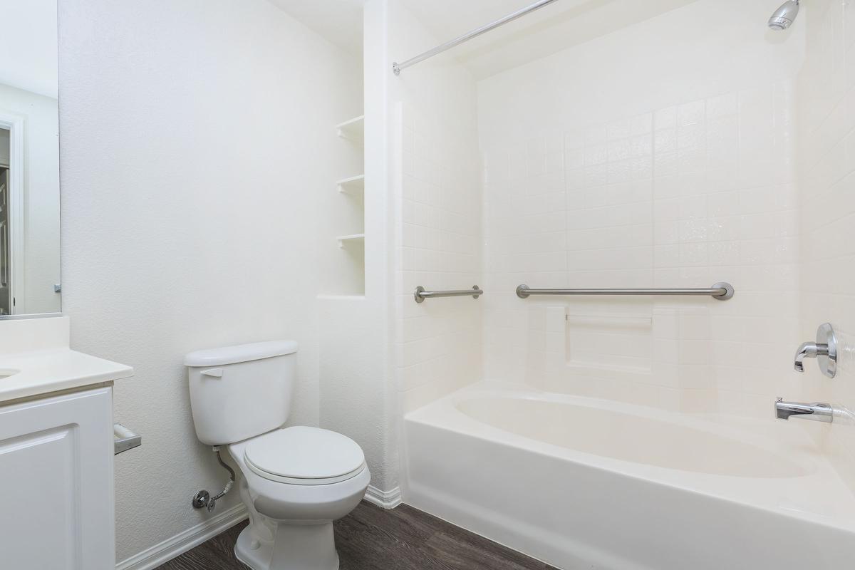 a white tub sitting next to a sink