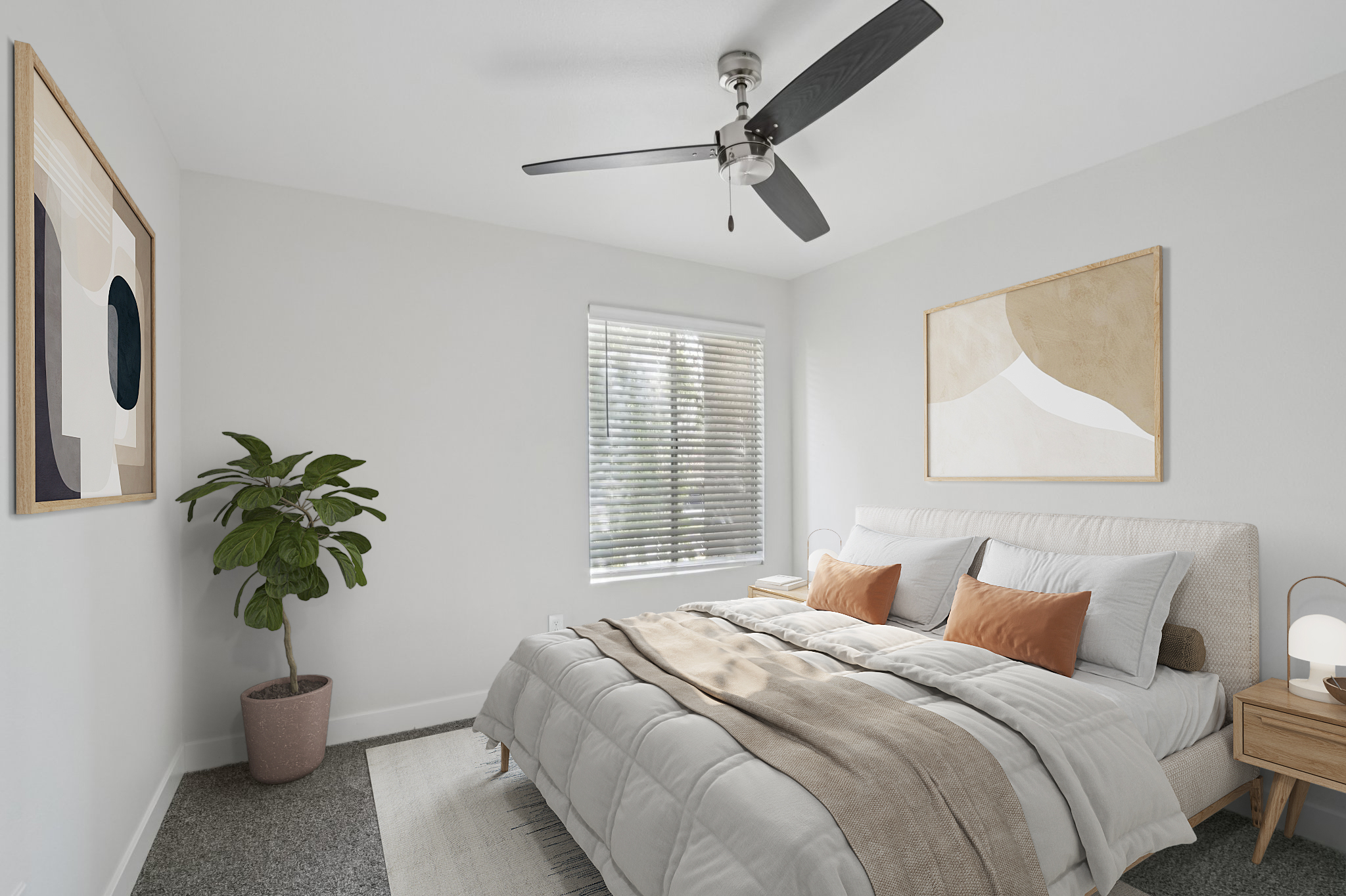 A bright, modern bedroom featuring a queen-sized bed with light gray bedding and two decorative pillows. A cozy area rug is on the floor, and there's a stylish plant in a pink pot. The room has white walls, wooden furniture, and two abstract art pieces hanging on the walls. A ceiling fan provides airflow.