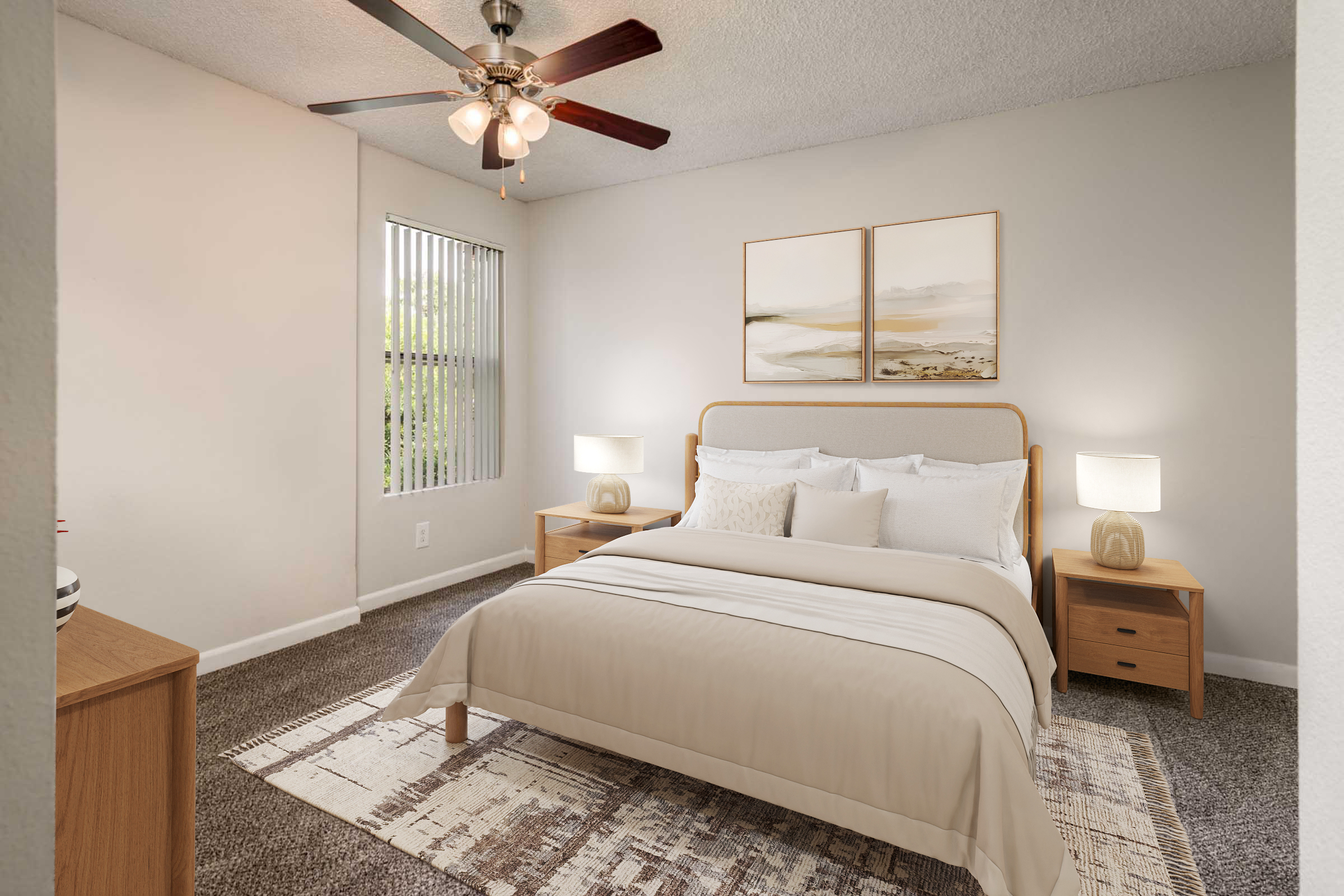 A cozy bedroom featuring a double bed with a beige comforter, two nightstands with lamps, and a window with vertical blinds. Above the bed, there are two decorative paintings. The ceiling has a fan, and the carpeted floor is complemented by a soft area rug, creating a relaxing atmosphere.