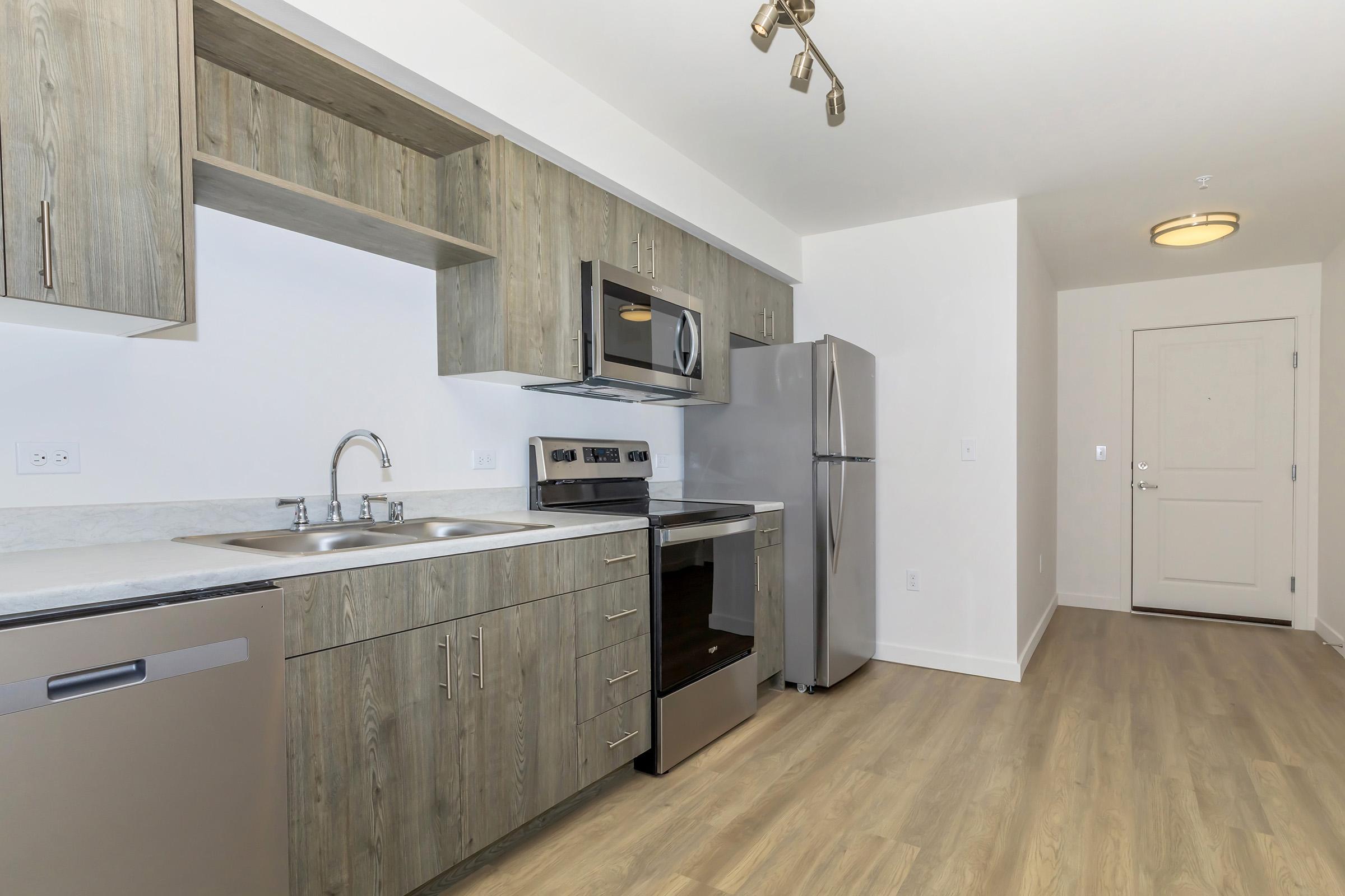 a large kitchen with stainless steel appliances