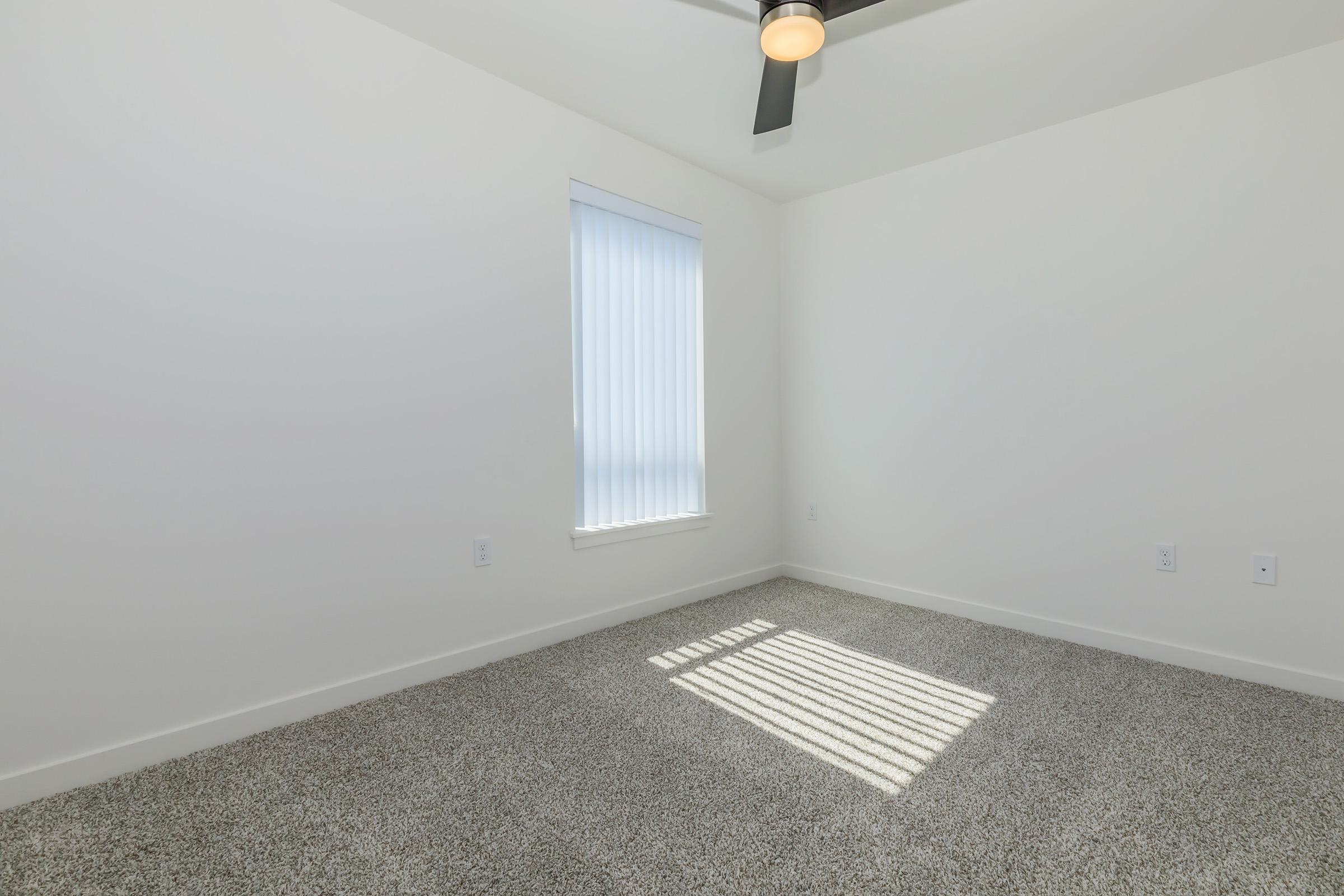 a bedroom with a large window