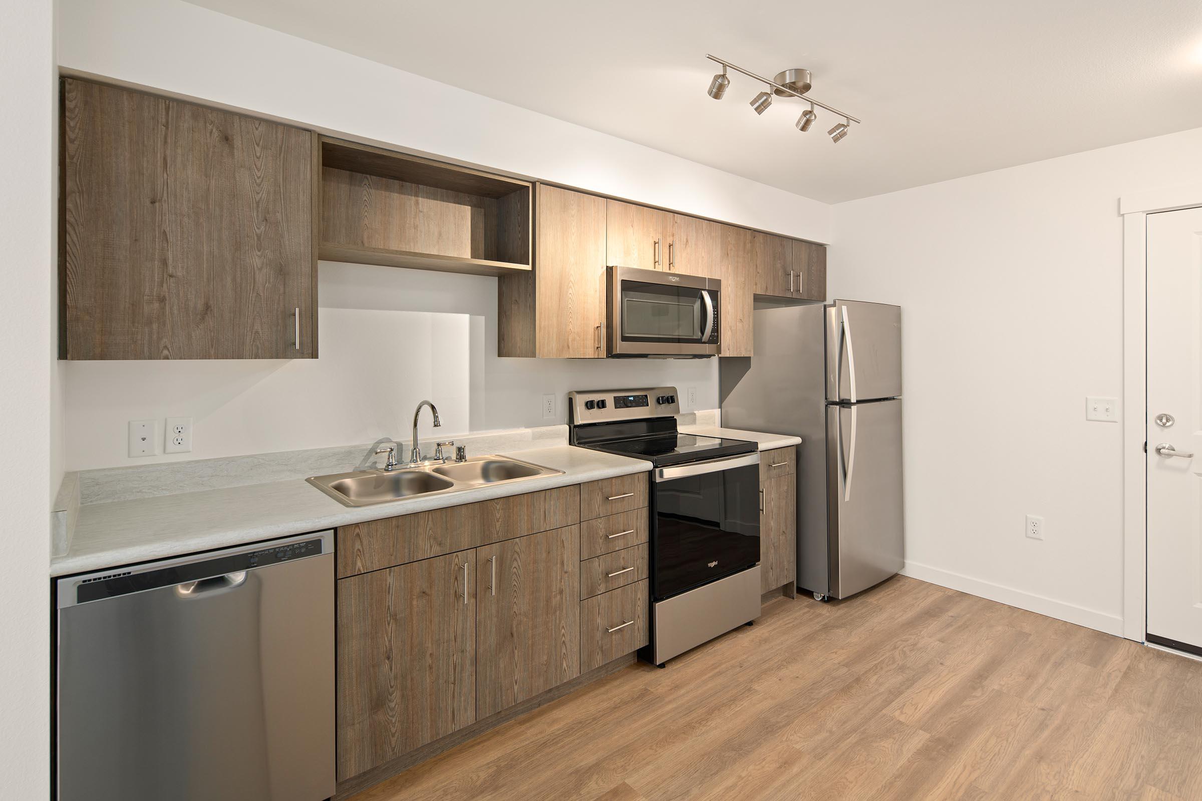 a kitchen with stainless steel appliances and wooden cabinets