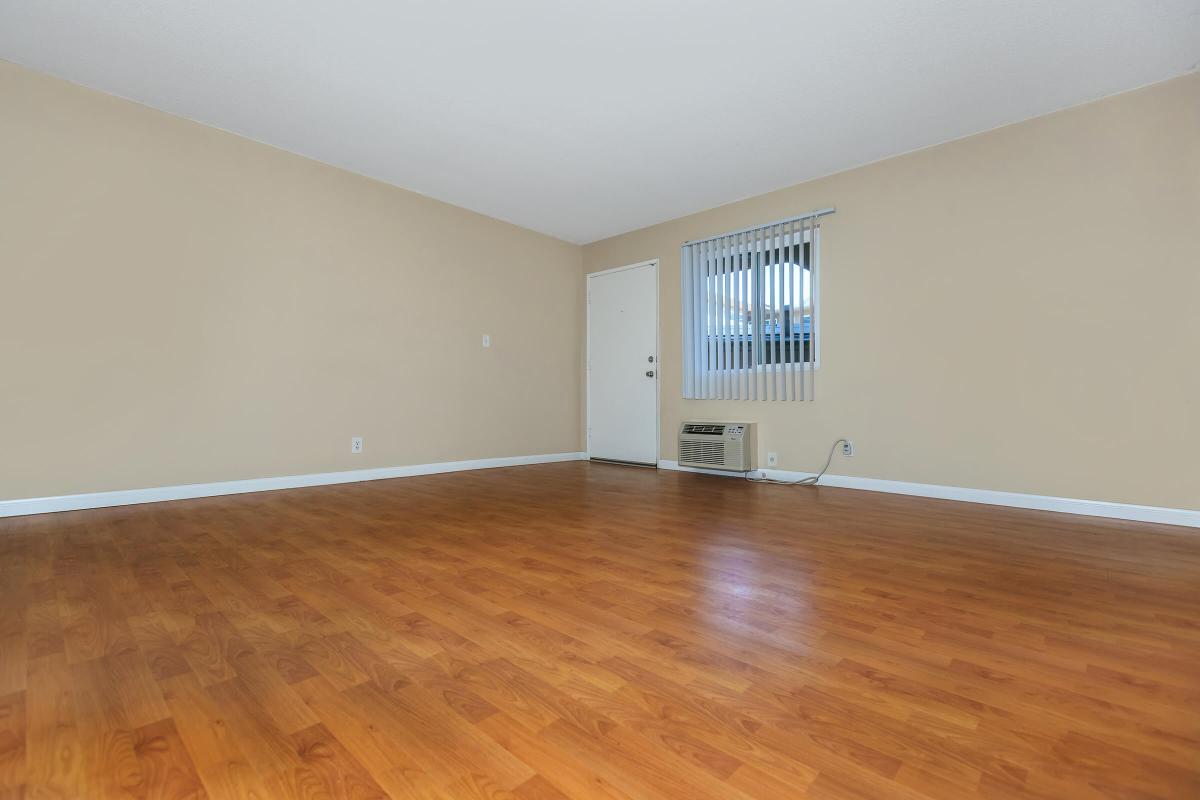 a large empty room with a hard wood floor